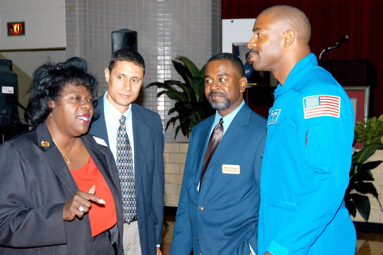 KENNEDY SPACE CENTER, FLA. - Astronaut Leland Melvin (far right) listens to Sarah Copelin-Wood (far left), chair of the Board of Education, at Ronald E. McNair High School in Atlanta, a NASA Explorer School. Melvin accompanied KSC Deputy Director Dr. Woodrow Whitlow Jr. on a visit to the school to share the vision for space exploration with the next generation of explorers. Whitlow talked with students about our destiny as explorers, NASA’s stepping stone approach to exploring Earth, the Moon, Mars and beyond, how space impacts our lives, and how people and machines rely on each other in space.
