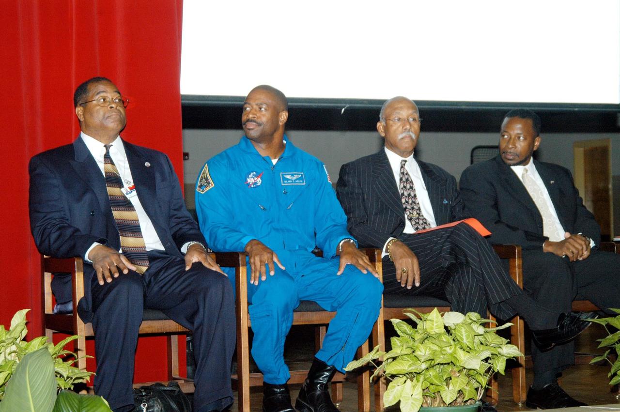 KENNEDY SPACE CENTER, FLA. - Principal Albert Sye, astronaut Leland Melvin, Dr. Julian Earls and KSC Deputy Director Dr. Woodrow Whitlow Jr. share the stage at Ronald E. McNair High School in Atlanta, a NASA Explorer School. Dr. Earls is director of the NASA Glenn Research Center. He joined Dr. Whitlow on a visit to the school to share the vision for space exploration with the next generation of explorers. Whitlow talked with students about our destiny as explorers, NASA’s stepping stone approach to exploring Earth, the Moon, Mars and beyond, how space impacts our lives, and how people and machines rely on each other in space. Dr. Earls discussed the future and the vision for space, plus the NASA careers needed to meet the vision. Melvin talked about the importance of teamwork and what it takes for mission success.