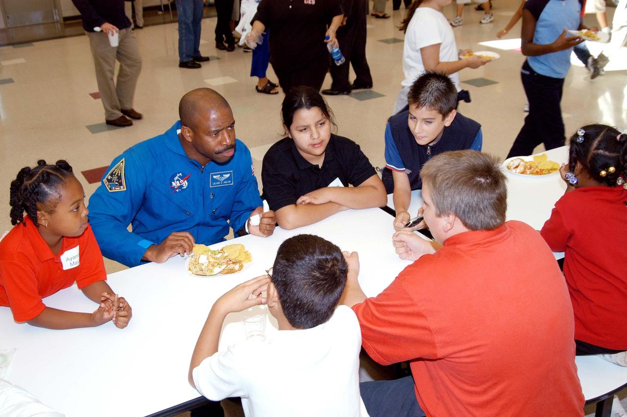 KENNEDY SPACE CENTER, FLA. -  Astronaut Leland Melvin joins students in the cafeteria at Gainesville Elementary School, a NASA Explorer School in Gainesville, Ga.  Melvin joined Jim Jennings, deputy associate administrator for Institutions and Asset Management at NASA Headquarters, on the visit to the school to share the new vision for space exploration with the next generation of explorers.  Melvin talked about the importance of teamwork and what it takes for mission success. Also visiting was KSC Deputy Director Woodrow Whitlow Jr., who talked with students about our destiny as explorers, NASA’s stepping stone approach to exploring Earth, the Moon, Mars and beyond, how space impacts our lives, and how people and machines rely on each other in space.