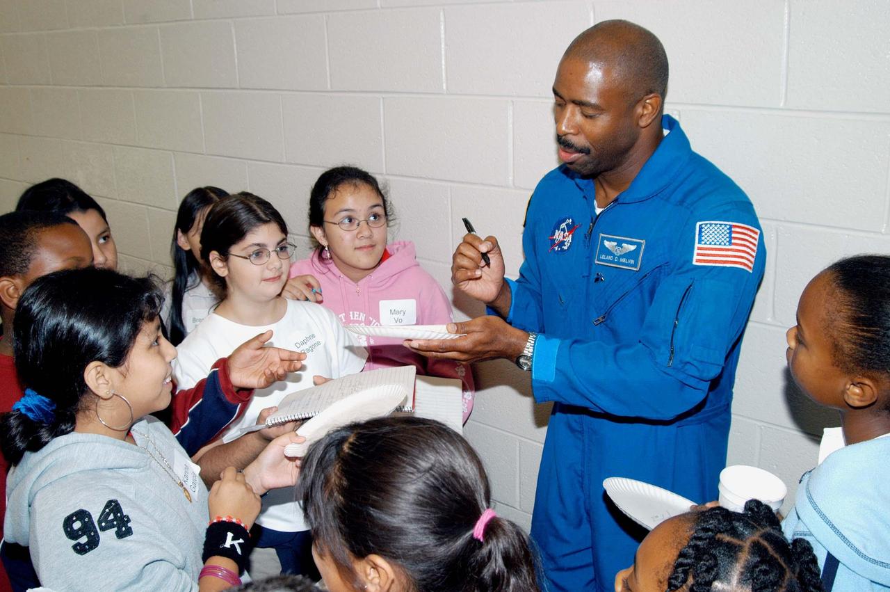 KENNEDY SPACE CENTER, FLA. - Astronaut Leland Melvin signs autographs for students at Gainesville Elementary School, a NASA Explorer School in Gainesville, Ga. Melvin joined Jim Jennings, deputy associate administrator for Institutions and Asset Management at NASA Headquarters, on the visit to the school to share the new vision for space exploration with the next generation of explorers. Melvin talked about the importance of teamwork and what it takes for mission success. Also visiting was KSC Deputy Director Woodrow Whitlow Jr., who talked with students about our destiny as explorers, NASA’s stepping stone approach to exploring Earth, the Moon, Mars and beyond, how space impacts our lives, and how people and machines rely on each other in space.