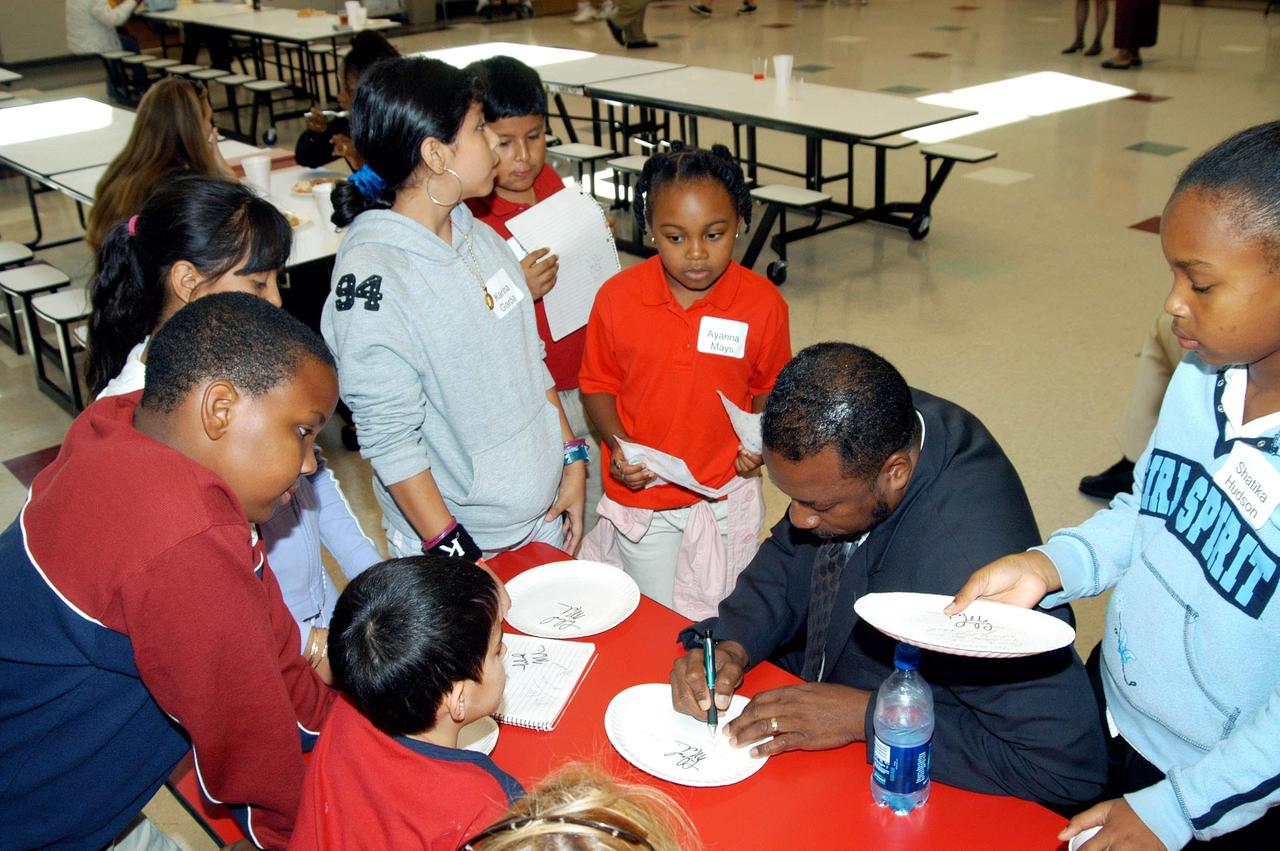 KENNEDY SPACE CENTER, FLA. - KSC Deputy Director Dr. Woodrow Whitlow Jr. signs autographs for students at Gainesville Elementary School, a NASA Explorer School in Gainesville, Ga. Whitlow accompanied Jim Jennings, deputy associate administrator for Institutions and Asset Management at NASA Headquarters, who visited the school to share the new vision for space exploration with the next generation of explorers. Whitlow talked with students about our destiny as explorers, NASA’s stepping stone approach to exploring Earth, the Moon, Mars and beyond, how space impacts our lives, and how people and machines rely on each other in space.