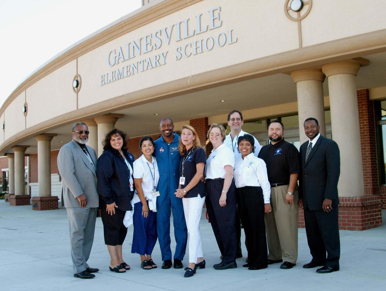 KENNEDY SPACE CENTER, FLA. - Outside Gainesville Elementary School, a NASA Explorer School in Gainesville, Ga., school staff members pose for this photo with Jim Jennings (far left), deputy associate administrator for Institutions and Asset Management at NASA Headquarters; astronaut Leland Melvin (center); and Dr. Woodrow Whitlow (far right), KSC deputy director. Jennings visited the school to share the new vision for space exploration with the next generation of explorers. Whitlow and Melvin accompanied him and talked with students about our destiny as explorers, NASA’s stepping stone approach to exploring Earth, the Moon, Mars and beyond, how space impacts our lives, and how people and machines rely on each other in space.