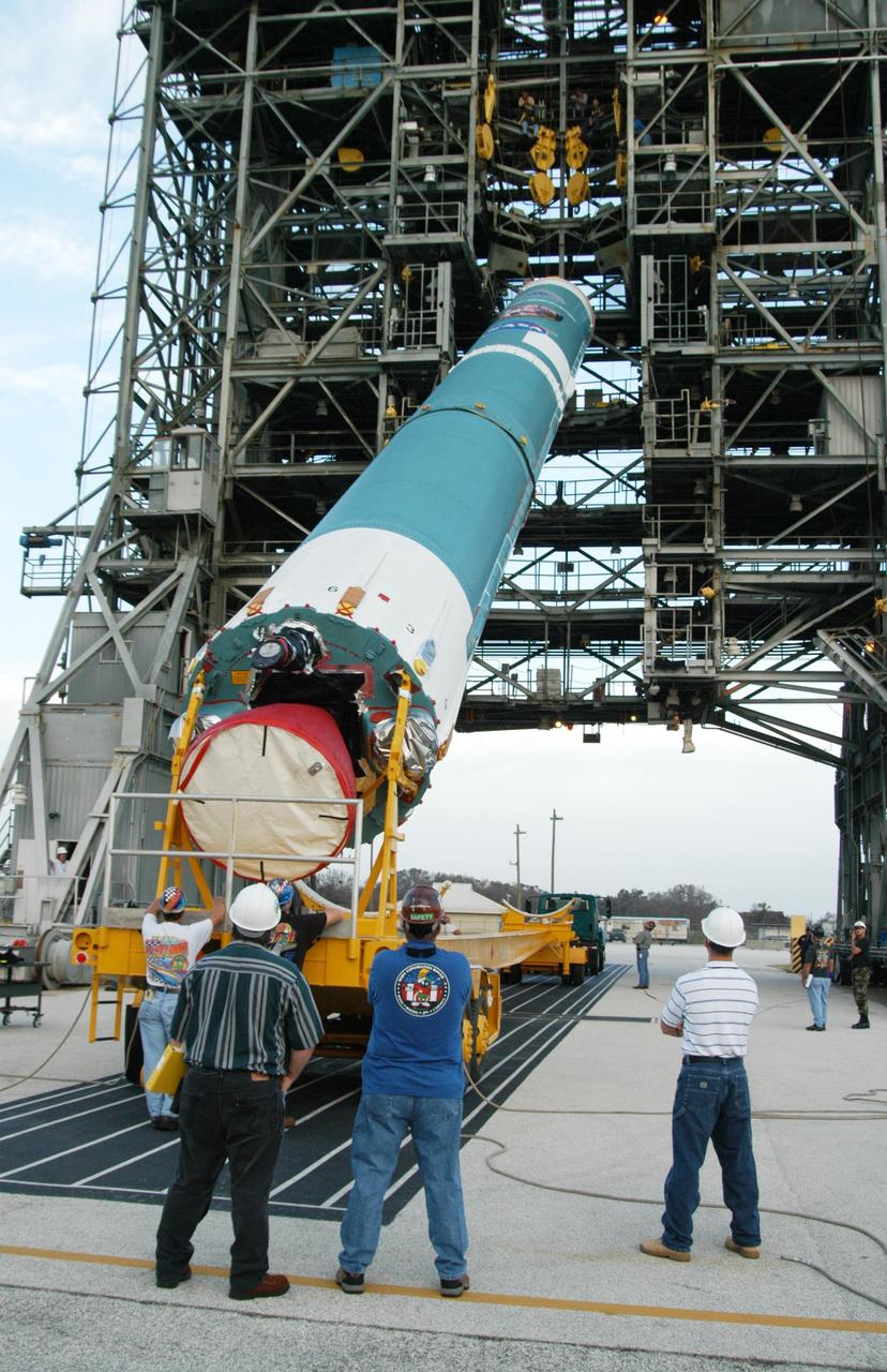 KENNEDY SPACE CENTER, FLA. -  On Launch Complex 17-A at Cape Canaveral Air Force Station, Fla., the first stage of a Boeing Delta II rocket is lifted off its transporter for transfer into the mobile service tower.  To follow in the next week are attachment of the three strap-on solid rocket boosters, lifting of the payload fairing, and lifting of the second stage for mating with the first stage.   The rocket is the launch vehicle for the Swift spacecraft and its Gamma-Ray Burst Mission, now scheduled for liftoff no earlier than Nov. 2.  Swift is a medium-class Explorer mission managed by NASA’s Goddard Space Flight Center in Greenbelt, Md.  The observatory was built for NASA by Spectrum Astro, a division of General Dynamics.  KSC is responsible for Swift’s integration with the Boeing Delta II rocket and the countdown management on launch day.