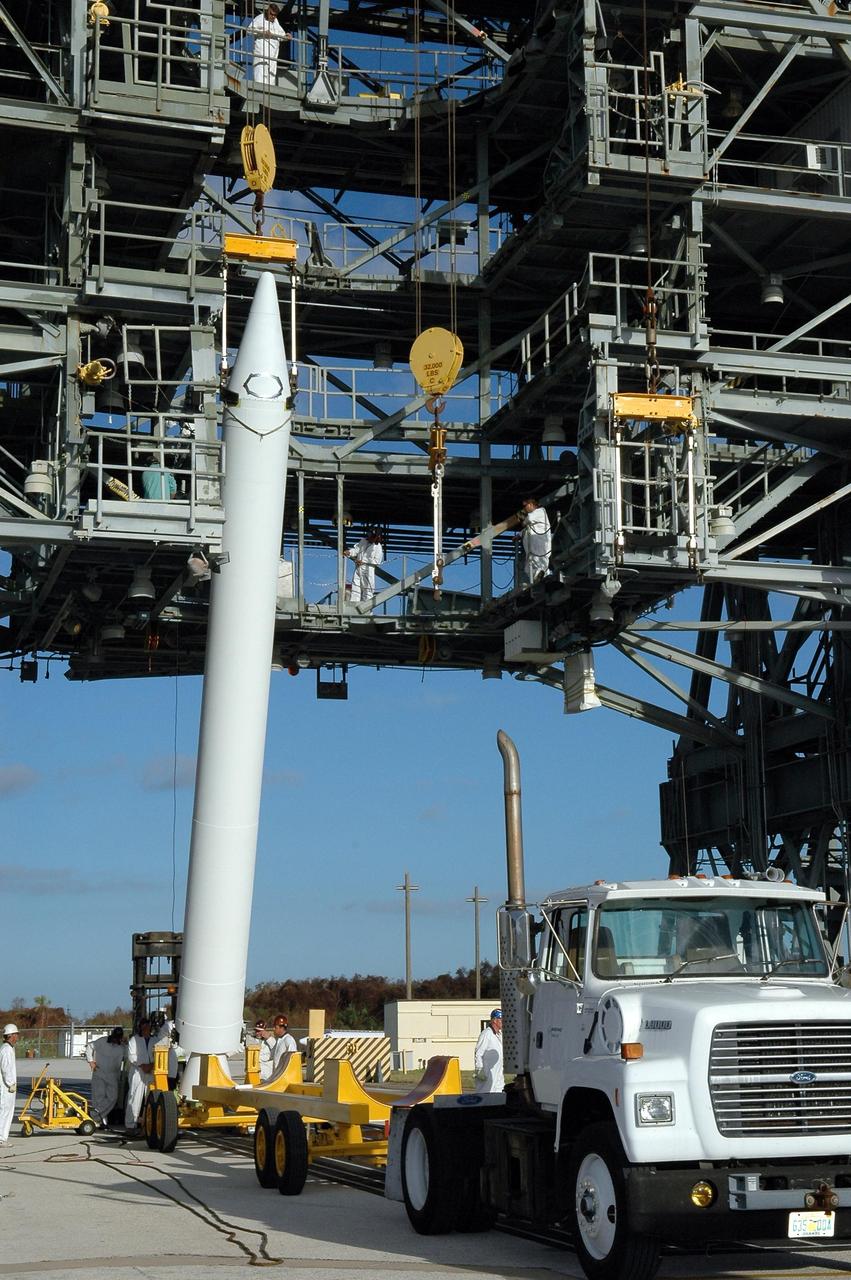 KENNEDY SPACE CENTER, FLA. - A Solid Rocket Booster for the Swift-Delta launch is lifted off its transporter on Pad 17-A at Cape Canaveral Air Force Station. The SRB is one of three to be attached to the Boeing Delta rocket that is the launch vehicle for the Swift spacecraft and its Gamma-Ray Burst Mission. Swift is a medium-class Explorer mission managed by NASA’s Goddard Space Flight Center in Greenbelt, Md.