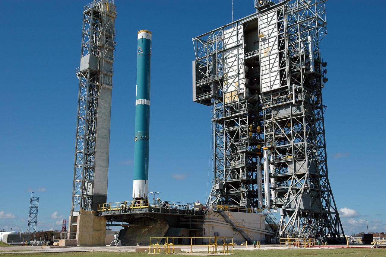 KENNEDY SPACE CENTER, FLA. - On Pad 17-A, Cape Canaveral Air Force Station, the mobile service tower at right moves with three Solid Rocket Boosters toward the Boeing Delta first stage at left. The three SRBs will be attached to the Boeing Delta launch vehicle for the Swift spacecraft and its Gamma-Ray Burst Mission. Swift is a medium-class Explorer mission managed by NASA’s Goddard Space Flight Center in Greenbelt, Md.