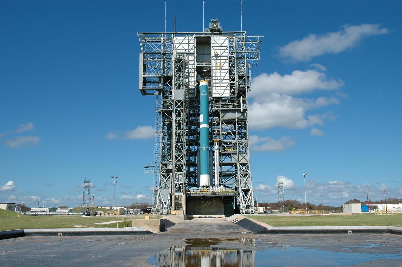 KENNEDY SPACE CENTER, FLA. - On Pad 17-A, Cape Canaveral Air Force Station, three Solid Rocket Boosters are moved into place around the Boeing Delta first stage. The three SRBs will be attached to the Boeing Delta launch vehicle for the Swift spacecraft and its Gamma-Ray Burst Mission. Swift is a medium-class Explorer mission managed by NASA’s Goddard Space Flight Center in Greenbelt, Md.
