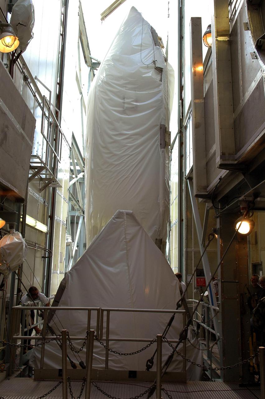 KENNEDY SPACE CENTER, FLA. - Both halves of the fairing have been separated after being lifted to the top of the mobile service tower on pad 17-A, Cape Canaveral Air Force Station. The fairing will encapsulate the Swift spacecraft and protect it while on the launch pad and during ascent. The Boeing Delta rocket is the launch vehicle for Swift and its Gamma-Ray Burst Mission. Swift is a medium-class Explorer mission managed by NASA’s Goddard Space Flight Center in Greenbelt, Md.