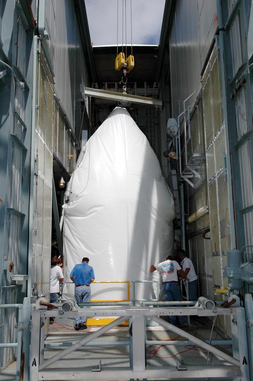 KENNEDY SPACE CENTER, FLA. - The fairing for the Swift-Delta launch reaches the top of the mobile service tower on pad 17-A, Cape Canaveral Air Force Station. The fairing will encapsulate the Swift spacecraft and protect it while on the launch pad and during ascent. The Boeing Delta rocket is the launch vehicle for Swift and its Gamma-Ray Burst Mission. Swift is a medium-class Explorer mission managed by NASA’s Goddard Space Flight Center in Greenbelt, Md.