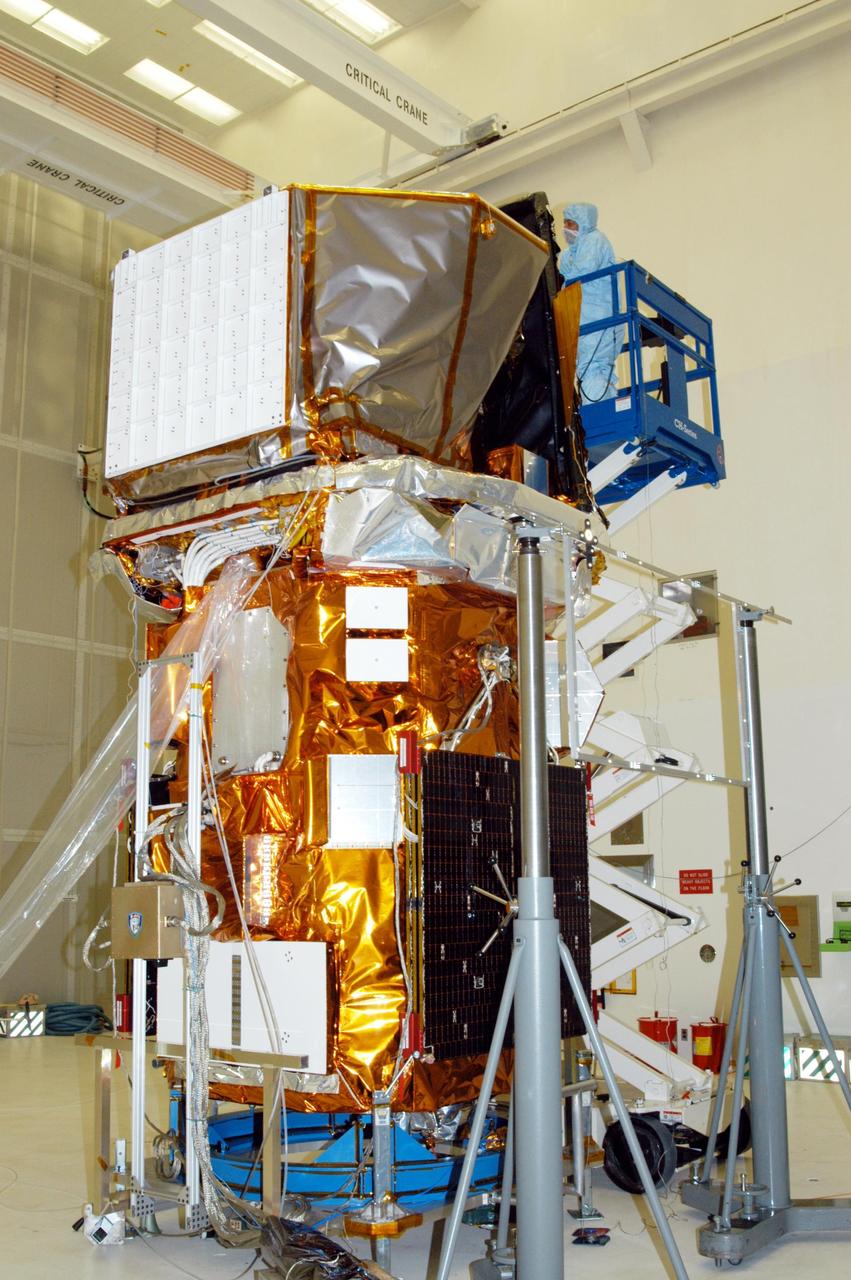 KENNEDY SPACE CENTER, FLA. - In Hangar AE at Cape Canaveral Air Force Station, a technician performs blanket closeouts on the Swift spacecraft.  The blankets provide thermal stability during the mission.  Swift is a first-of-its-kind multi-wavelength observatory dedicated to the study of gamma-ray burst (GRB) science. Its three instruments will work together to observe GRBs and afterglows in the gamma ray, X-ray, ultraviolet and optical wavebands. The most comprehensive study of GRB afterglows to date, Swift is expected to observe more than 200 gamma-ray bursts during its 2-year mission.