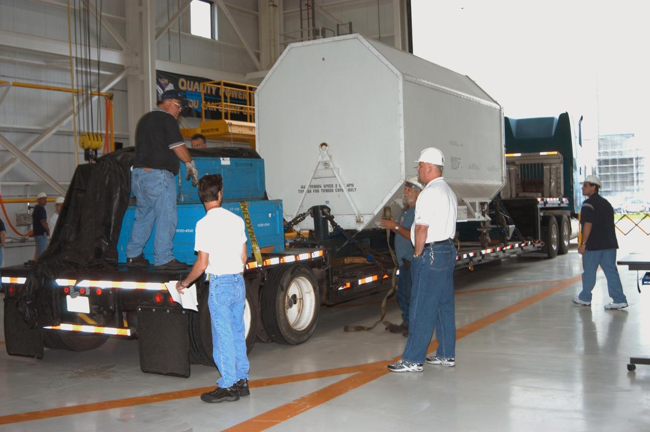 KENNEDY SPACE CENTER, FLA. -  Enclosed inside the shipping container, the third Space Shuttle Main Engine for Discovery’s Return to Flight mission STS-114 arrives at the KSC Engine Shop aboard a trailer.  The engine is returning from NASA’s Stennis Space Center in Mississippi where it underwent a hot fire acceptance test. Typically, the engines are installed on an orbiter in the Orbiter Processing Facility approximately five months before launch.