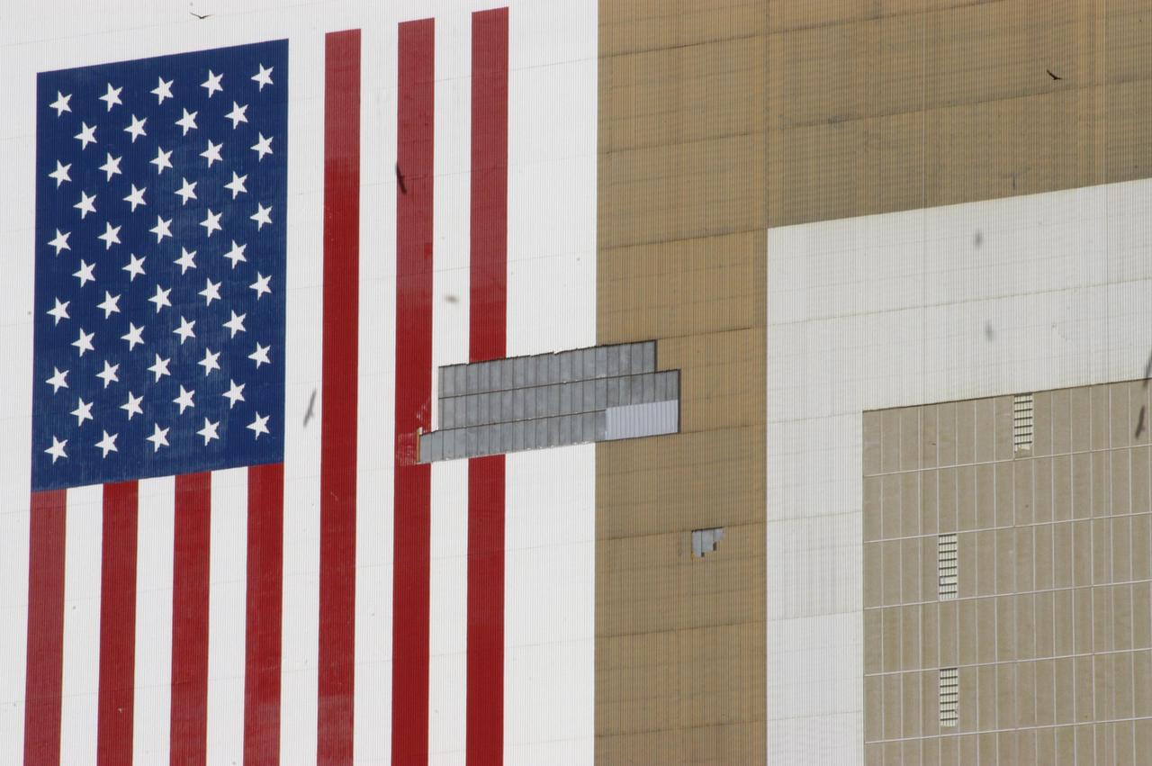 KENNEDY SPACE CENTER, FLA. - This closeup of the Vehicle Assembly Building at KSC shows some of the patchwork of corrugated steel that covers holes created by recent hurricanes.  The VAB lost 820 panels from the south wall during Hurricane Frances, and 25 additional panels pulled off the east wall by Hurricane Jeanne.  Employees of Met-Con, a subcontractor in Cocoa, Fla., worked night and day on scaffolds hung from the 525-foot-high roof to close the holes and enable the facility to return to normal operations.