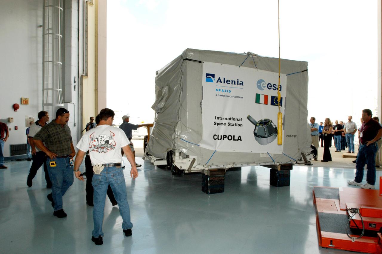 KENNEDY SPACE CENTER, FLA. - At the Space Station Processing Facility, a trailer delivers the Cupola, an element scheduled to be installed on the International Space Station in early 2009. It was shipped from Alenia Spazio in Turin, Italy, for the European Space Agency.  A dome-shaped module with seven windows, the Cupola will give astronauts a panoramic view for observing many operations on the outside of the orbiting complex.  The view out of the Cupola windows will enhance an arm operator's situational awareness, supplementing television camera views and graphics.  It will provide external observation capabilities during spacewalks, docking operations and hardware surveys and for Earth and celestial studies. The Cupola is the final element of the Space Station core.