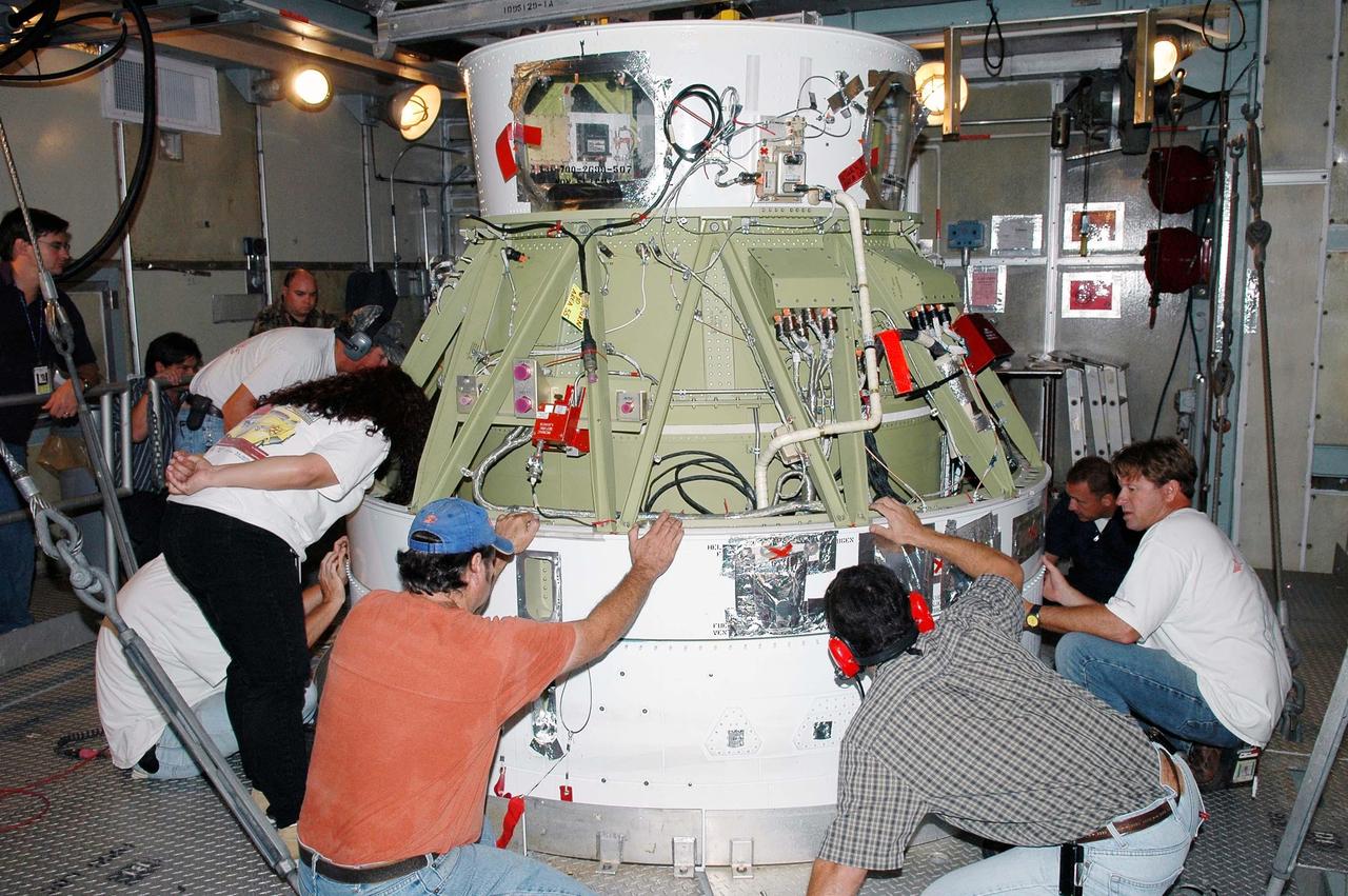 KENNEDY SPACE CENTER, FLA. - In the mobile service tower at Launch Pad 17-A on Cape Canaveral Air Force Station, workers attach the upper second stage to the lower first stage of the Boeing Delta II launch vehicle. The rocket is the launch vehicle for the Swift spacecraft and its Gamma-Ray Burst Mission, now scheduled for liftoff Nov. 8. Swift is a medium-class Explorer mission managed by NASA’s Goddard Space Flight Center in Greenbelt, Md. It is a first-of-its-kind multi-wavelength observatory dedicated to the study of gamma-ray burst (GRB) science. Its three instruments will work together to observe GRBs and afterglows in the gamma ray, X-ray, ultraviolet and optical wavebands. KSC is responsible for Swift’s integration with the Boeing Delta II rocket and the countdown management on launch day.