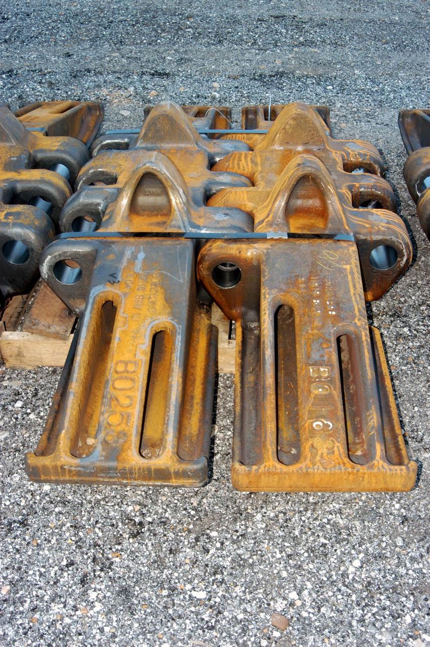 KENNEDY SPACE CENTER, FLA. - A closeup of some of the new crawler shoes that arrived from Minnesota. The new shoes were manufactured by ME Global in Duluth. The CT transports the Mobile Launcher Platform, with the assembled Space Shuttle aboard, between the refurbishment area, the VAB and Launch Complex Pads 39A and 39B. The crawlers have 456 shoes, 57 per belt (8 belts in all). Each shoe weighs 2,200 pounds. The original shoes were manufactured for the Apollo Program. Cracks appeared in the shoes in recent years spurring a need for replacement. The new manufacturer, in Duluth, Minn., has improved the design for Return to Flight and use through the balance of the Space Shuttle Program.