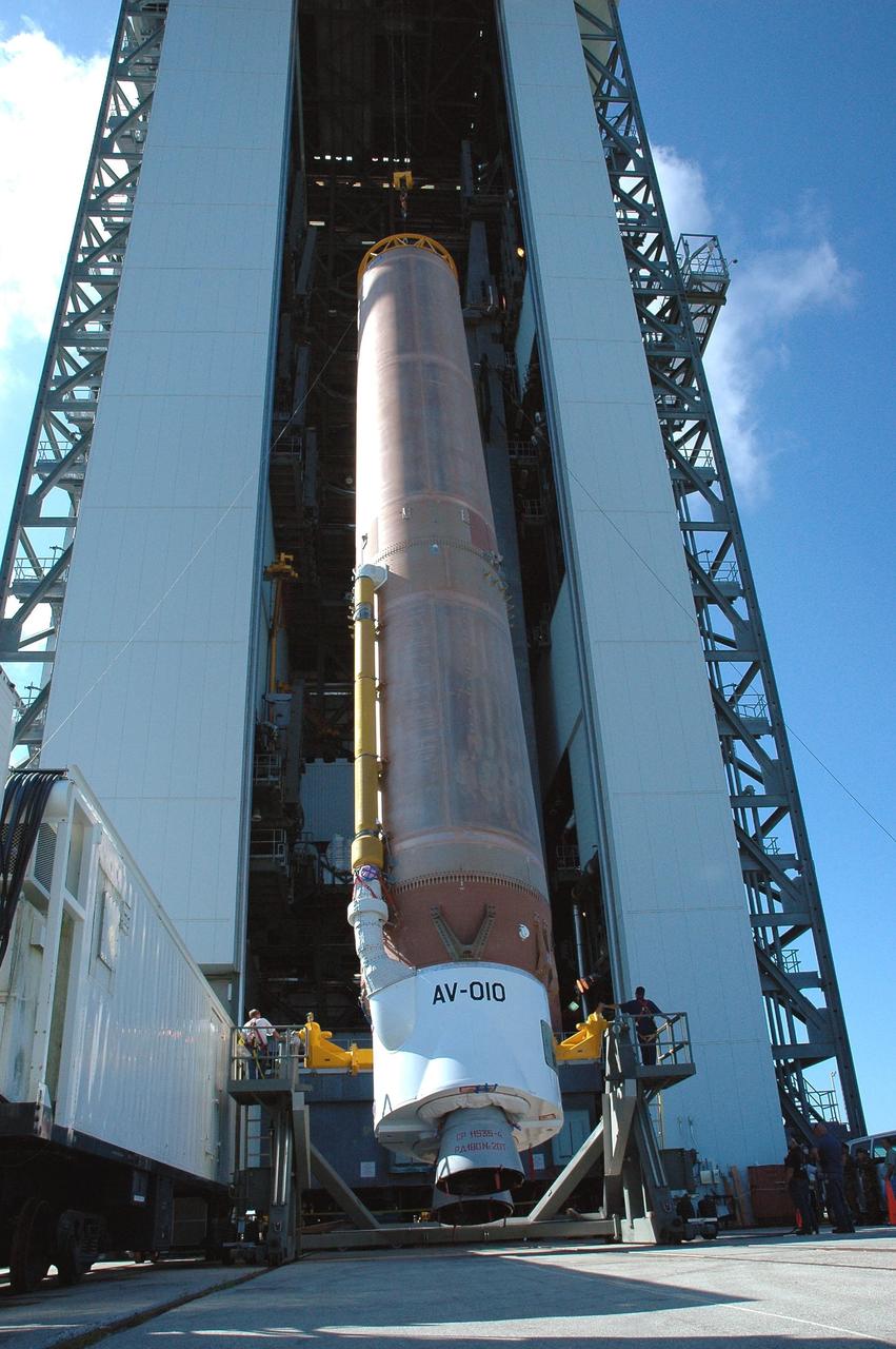 KENNEDY SPACE CENTER, FLA. - On Launch Complex 41 at Cape Canaveral Air Force Station, the first stage of an Atlas V rocket is nearly vertical. The rocket will be moved into the Vertical Integration Facility to begin preparations for launch. The Lockheed Martin Atlas V is the launch vehicle for the New Horizons spacecraft, which is designed to make the first reconnaissance of Pluto and Charon - a "double planet" and the last planet in our solar system to be visited by spacecraft. The mission will then visit one or more objects in the Kuiper Belt region beyond Neptune. New Horizons is scheduled to launch in January 2006, swing past Jupiter for a gravity boost and scientific studies in February or March 2007, and reach Pluto and its moon, Charon, in July 2015.