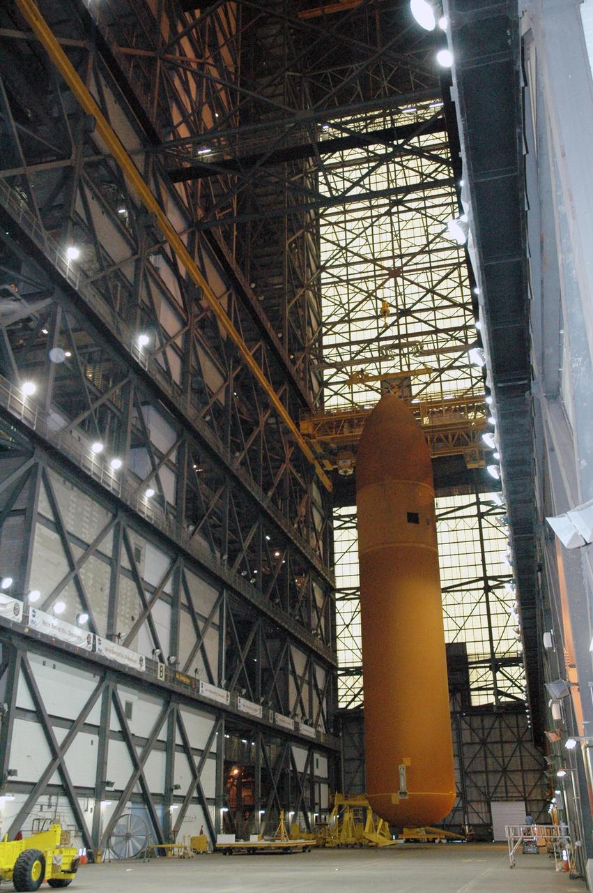 KENNEDY SPACE CENTER, FLA. - The 154.2-foot-high external tank #120 is suspended above the transfer aisle of NASA Kennedy Space Center’s Vehicle Assembly Building. It will be lowered to a horizontal position and placed on a transporter to wait for the return of the Pegasus barge from delivering tank #119 to Louisiana. In a few weeks, tank #120 also will be returned to NASA’s Michoud Assembly Facility in Louisiana for routine testing and maintenance. This tank is the first of the newly designed tanks that were delivered to Kennedy. Previously stacked with Discovery, the tank has already gone through two tanking cycles during tanking tests but was replaced with tank #121 for Discovery’s return to flight mission STS-114