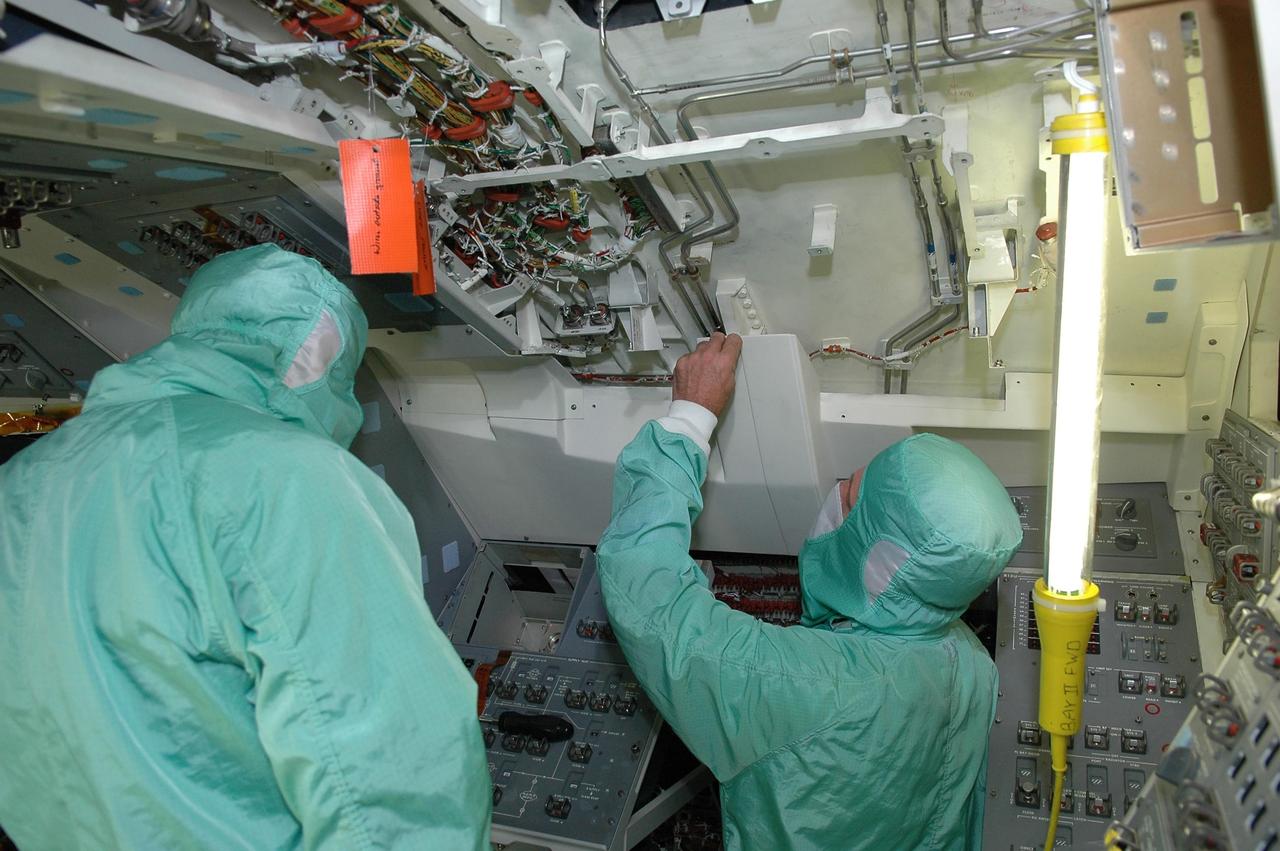 KENNEDY SPACE CENTER, FLA. -   In bay 2 of the Orbiter Processing Facility, workers are installing the Multifunction Electronic Display Subsystem  - a state-of-the-art “glass cockpit” - on the orbiter Endeavour.  The “bunny suits” they are wearing are clean room attire required for anyone coming in close proximity to the orbiter.  The full-color, flat-panel MEDS upgrade improves crew/orbiter interaction with easy-to-read, graphic portrayals of key flight indicators like attitude display and mach speed.  Endeavour is undergoing major modifications, which include inspecting more than 150 miles of wiring and bonding 1,000 thermal tiles, along with installing the display system.
