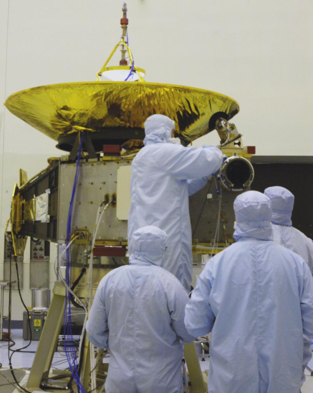KENNEDY SPACE CENTER, FLA. - In the NASA Kennedy Space Center’s Payload Hazardous Servicing Facility, technicians are installing the Solar Wind Around Pluto (SWAP) instrument on the New Horizons spacecraft.  New Horizons will make the first reconnaissance of Pluto and Charon - a "double planet" and the last planet in our solar system to be visited by spacecraft. The mission will then visit one or more objects in the Kuiper Belt region beyond Neptune. SWAP is a solar wind and plasma spectrometer that measures atmospheric “escape rate” and will observe Pluto’s interaction with the solar wind.  New Horizons is scheduled to launch in January 2006, swing past Jupiter for a gravity boost and scientific studies in February or March 2007, and reach Pluto and its moon, Charon, in July 2015.