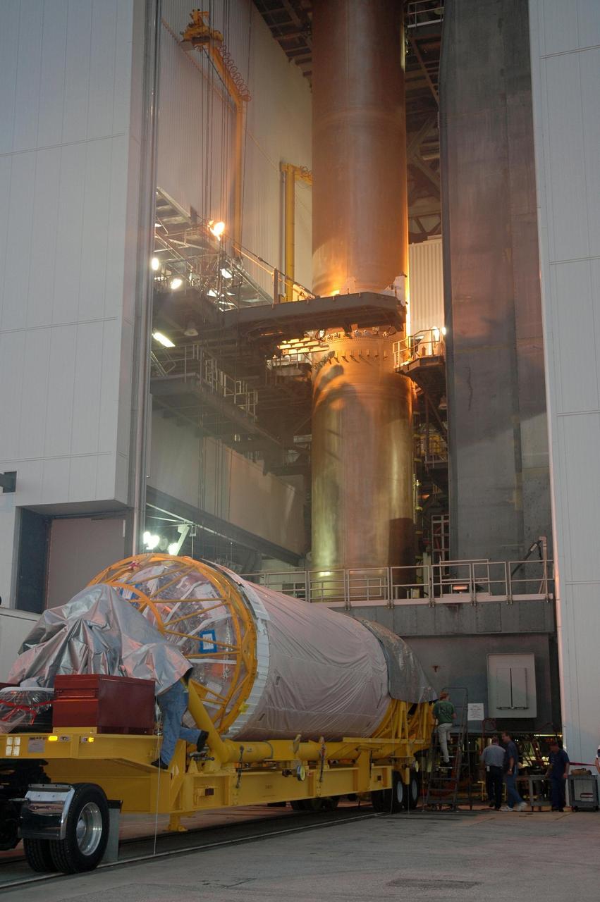 KENNEDY SPACE CENTER, FLA. -   The Lockheed Martin Atlas V Centaur stage arrives at the mobile service tower on Launch Complex 41 at Cape Canaveral Air Force Station in Florida.  The Centaur is the second stage of the launch vehicle for the New Horizons spacecraft. Seen in the tower is the first stage.   New Horizons will make the first reconnaissance of Pluto and its moon, Charon - a "double planet" and the last planet in our solar system to be visited by spacecraft. As it approaches Pluto, the spacecraft will look for ultraviolet emission from Pluto's atmosphere and make the best global maps of Pluto and Charon in green, blue, red and a special wavelength that is sensitive to methane frost on the surface. It will also take spectral maps in the near infrared, telling the science team about Pluto's and Charon's surface compositions and locations and temperatures of these materials. When the spacecraft is closest to Pluto or its moon, it will take close-up pictures in both visible and near-infrared wavelengths. The mission will then visit one or more objects in the Kuiper Belt region beyond Neptune. New Horizons is scheduled to launch in January 2006, swing past Jupiter for a gravity boost and scientific studies in February or March 2007, and reach Pluto and Charon in July 2015.