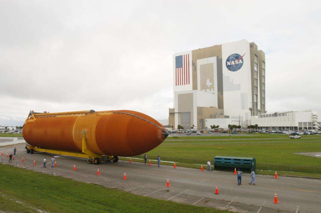 KENNEDY SPACE CENTER, FLA. -  External tank 120 is moved from NASA Kennedy Space Center’s Vehicle Assembly Building (in the background) to the Turn Basin and the waiting barge Pegasus.  The tank will be loaded onto the barge for transport to NASA’s Michoud Assembly Facility in Louisiana for additional modifications. This tank is the first of the newly designed tanks that were delivered to Kennedy.  Previously, the tank was stacked with Discovery and, more recently, Atlantis.  The tank has already gone through two tanking cycles during tanking tests but was replaced with tank #121 for Discovery’s return to flight mission STS-114.