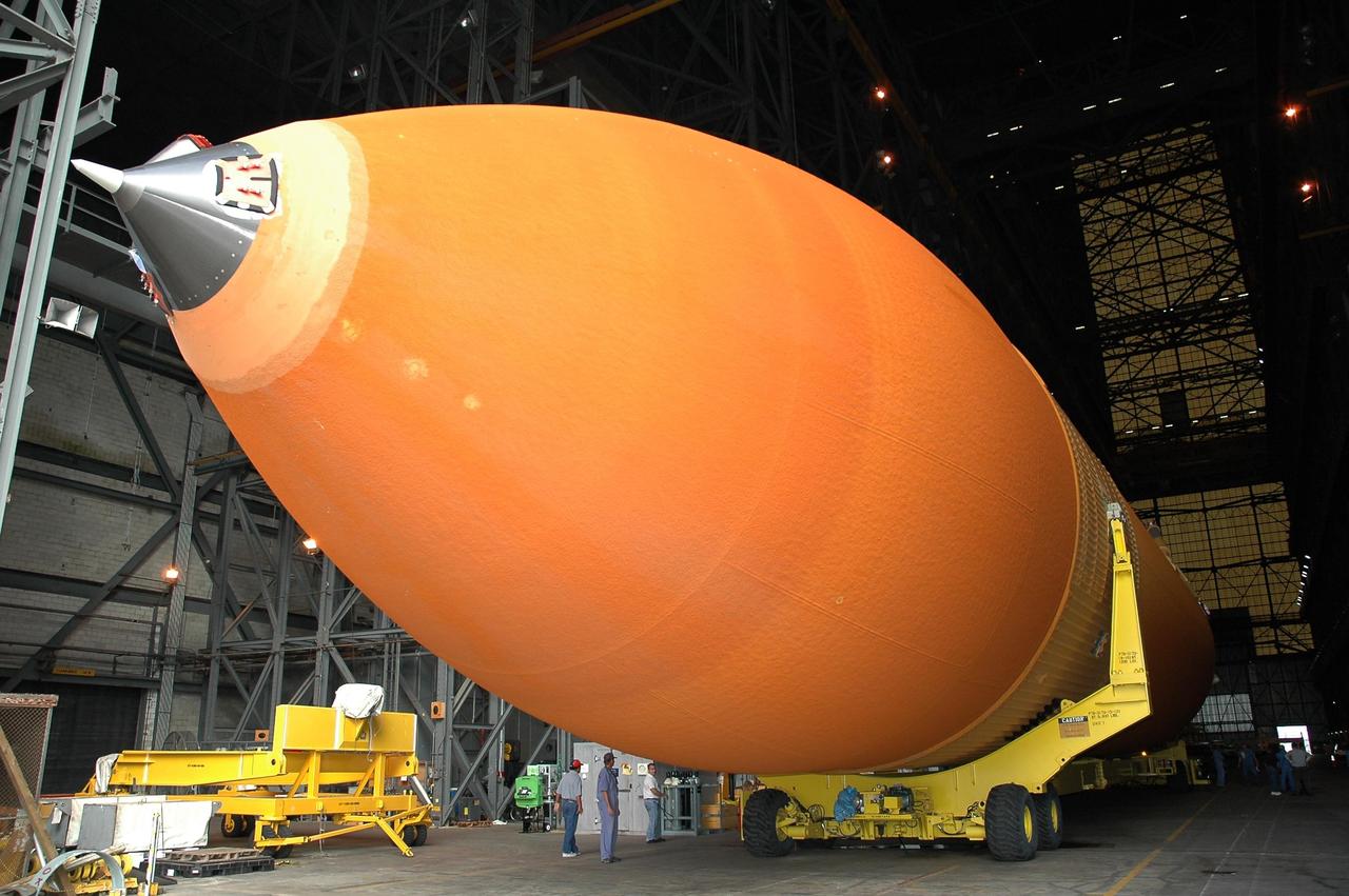 KENNEDY SPACE CENTER, FLA. -  External tank #120 rests on a transporter in NASA Kennedy Space Center’s Vehicle Assembly Building.  The tank will be moved to the nearby Turn Basin and loaded onto the barge Pegasus for towing to NASA’s Michoud Assembly Facility in Louisiana for additional modifications.  This tank is the first of the newly designed tanks that were delivered to Kennedy.  Previously, the tank was stacked with Discovery and, more recently, Atlantis.  The tank has already gone through two tanking cycles during tanking tests but was replaced with tank #121 for Discovery’s return to flight mission STS-114.