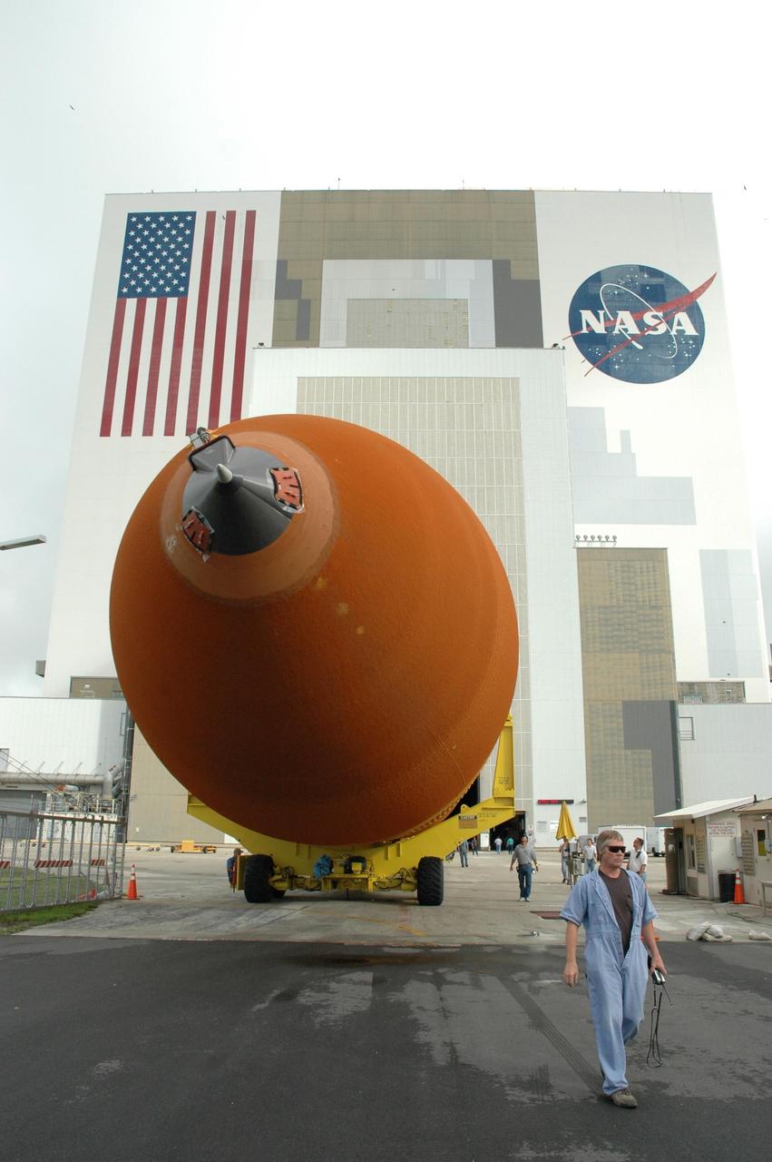 KENNEDY SPACE CENTER, FLA. -  External tank #120 moves out of NASA Kennedy Space Center’s Vehicle Assembly Building (behind it).  The tank is being moved to the nearby Turn Basin and will be loaded onto the barge Pegasus for towing to NASA’s Michoud Assembly Facility in Louisiana for additional modifications.  This tank is the first of the newly designed tanks that were delivered to Kennedy.  Previously, the tank was stacked with Discovery and, more recently, Atlantis.  The tank has already gone through two tanking cycles during tanking tests but was replaced with tank #121 for Discovery’s return to flight mission STS-114.