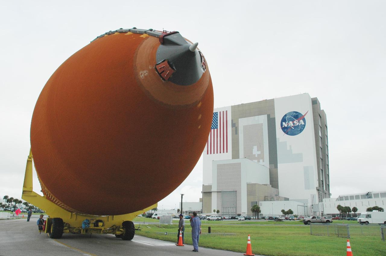 KENNEDY SPACE CENTER, FLA. -  External tank #120 makes the turn toward the nearby Turn Basin.  It is being moved from NASA Kennedy Space Center’s Vehicle Assembly Building (behind it).  The tank will be loaded onto the barge Pegasus for towing to NASA’s Michoud Assembly Facility in Louisiana for additional modifications.  This tank is the first of the newly designed tanks that were delivered to Kennedy.  Previously, the tank was stacked with Discovery and, more recently, Atlantis.  The tank has already gone through two tanking cycles during tanking tests but was replaced with tank #121 for Discovery’s return to flight mission STS-114.