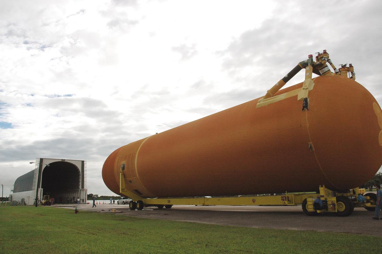 KENNEDY SPACE CENTER, FLA. -  External tank #120 approaches the barge Pegasus, docked at the Turn Basin on NASA’s Kennedy Space Center. When the tank is loaded onto the barge, it will be towed to NASA’s Michoud Assembly Facility in Louisiana for additional modifications.  This tank is the first of the newly designed tanks that were delivered to Kennedy.  Previously, the tank was stacked with Discovery and, more recently, Atlantis.  The tank has already gone through two tanking cycles during tanking tests but was replaced with tank #121 for Discovery’s return to flight mission STS-114.