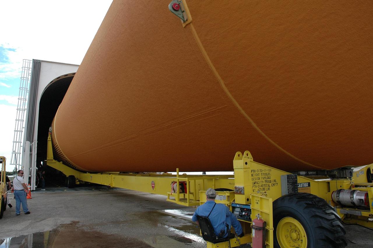 KENNEDY SPACE CENTER, FLA. -  External tank #120 is carefully maneuvered onto the barge Pegasus, docked at the Turn Basin on NASA’s Kennedy Space Center. After the tank is loaded onto the barge, it will be transported to NASA’s Michoud Assembly Facility in Louisiana for additional modifications.  This tank is the first of the newly designed tanks that were delivered to Kennedy.  Previously, the tank was stacked with Discovery and, more recently, Atlantis.  The tank has already gone through two tanking cycles during tanking tests but was replaced with tank #121 for Discovery’s return to flight mission STS-114.