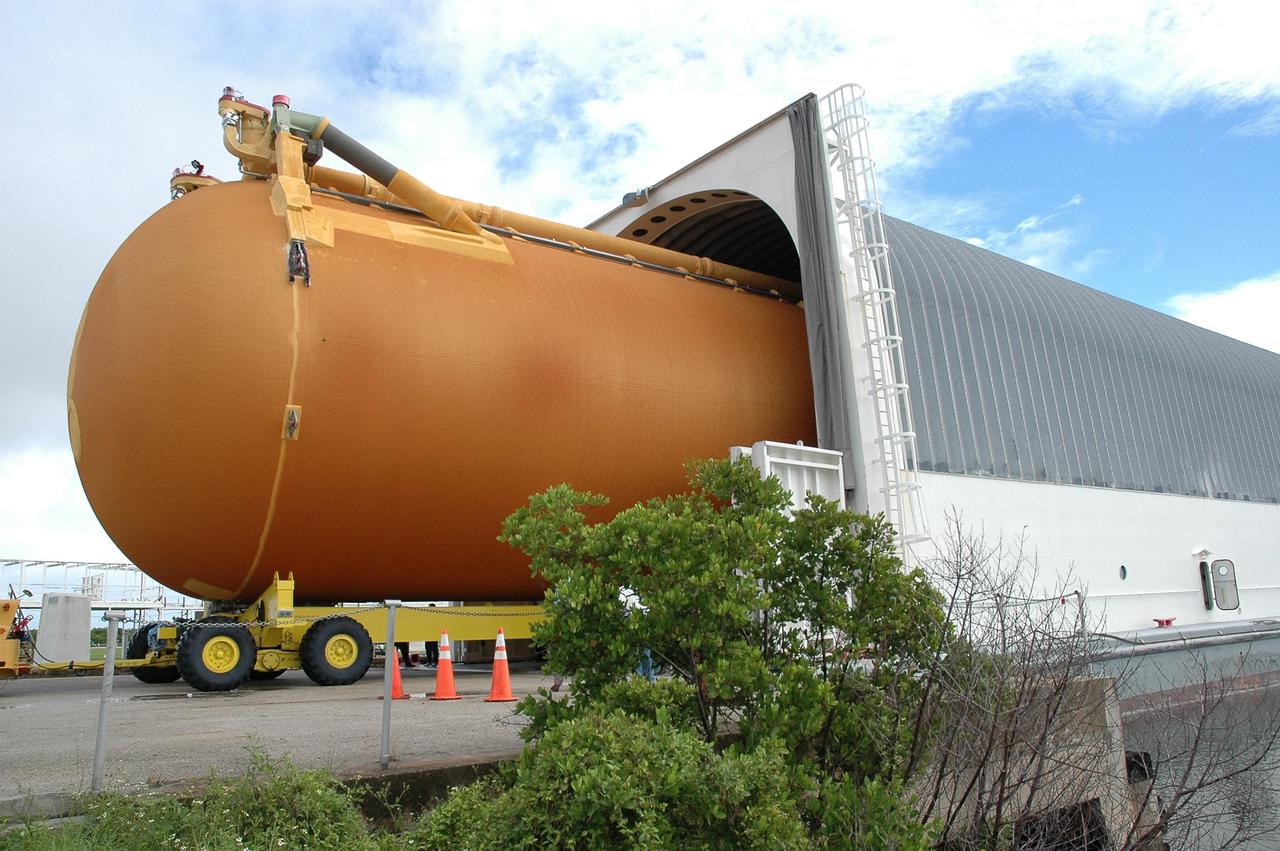 KENNEDY SPACE CENTER, FLA. -  External tank #120 rolls into the barge Pegasus, docked at the Turn Basin on NASA’s Kennedy Space Center. After the tank is fully loaded onto the barge, it will be towed to NASA’s Michoud Assembly Facility in Louisiana for additional modifications.   This tank is the first of the newly designed tanks that were delivered to Kennedy.  Previously, the tank was stacked with Discovery and, more recently, Atlantis.  The tank has already gone through two tanking cycles during tanking tests but was replaced with tank #121 for Discovery’s return to flight mission STS-114.