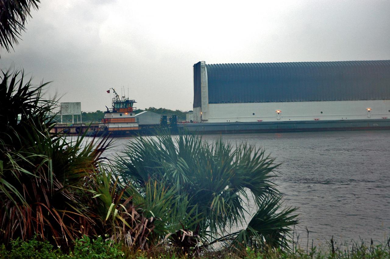KENNEDY SPACE CENTER, FLA. -   The Pegasus barge (right) is pushed away from the dock in the Turn Basin at NASA’s Kennedy Space Center.  The barge is carrying external tank #120, which is being returned to NASA’s Michoud Assembly Facility in Louisiana for additional modifications.  The barge is being moved to Port Canaveral where one of NASA’s solid rocket booster retrieval ships will take it and tow it around the Florida peninsula to Michoud.  This tank is the first of the newly designed tanks that were delivered to Kennedy.  Previously, the tank was stacked with Discovery and, more recently, Atlantis.  The tank has already gone through two tanking cycles during tanking tests but was replaced with tank #121 for Discovery’s return to flight mission STS-114.