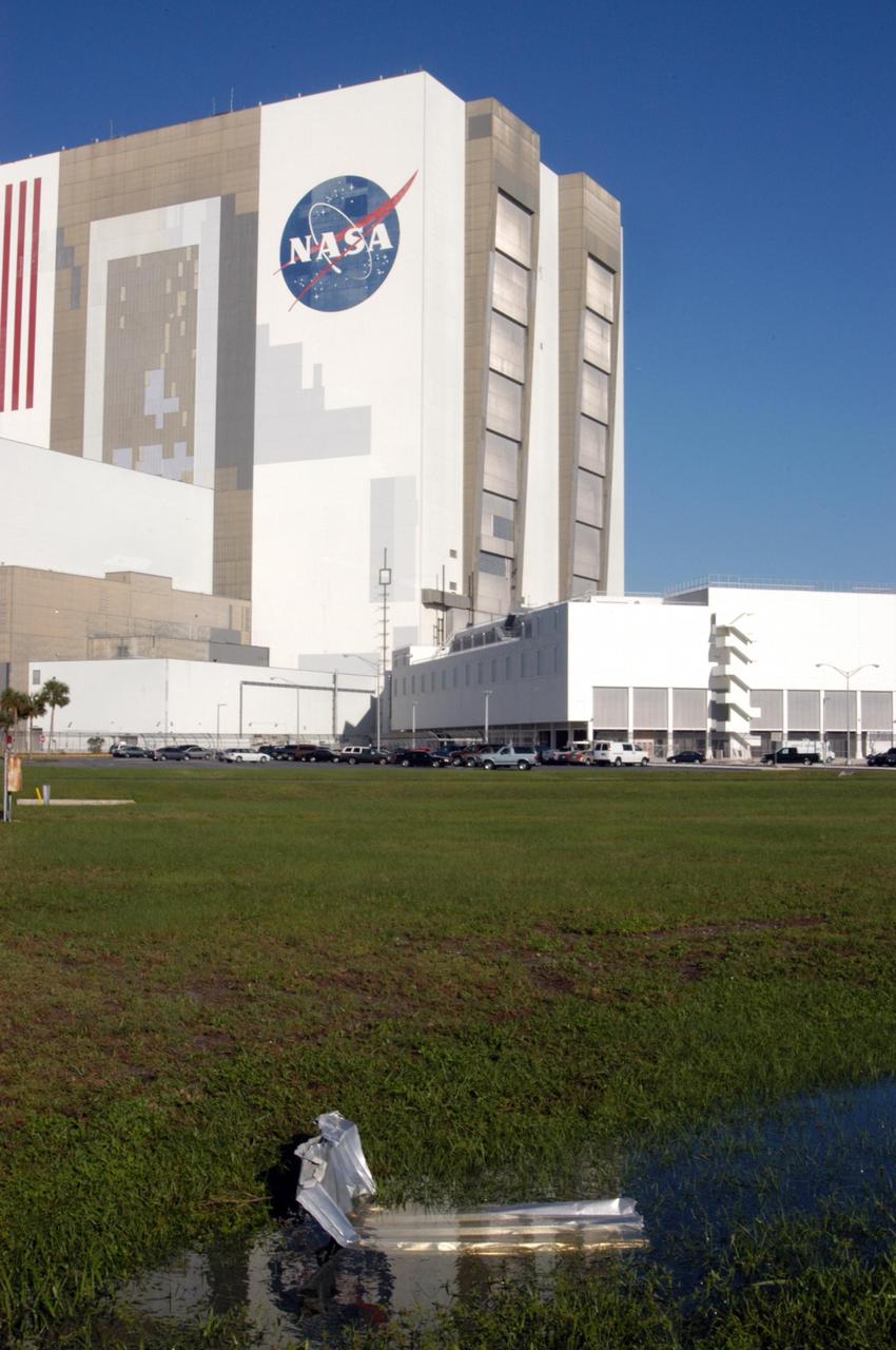 KENNEDY SPACE CENTER, FLA. - A piece of metal lies on the ground near the NASA Kennedy Space Center’s Vehicle Assembly Building following the wrath of hurricane Wilma as it crossed the state Oct. 24. Kennedy’s facilities sustained minor structural damage, primarily to roofs or from water intrusion. The Vehicle Assembly Building lost some panels on the east and west sides. Some facilities lost power. A total of 13.6 inches of rain was recorded at the Shuttle Landing Facility. The highest wind gust recorded was 94 mph from the north-northwest at Launch Pad 39B, while the maximum sustained wind was 76 mph from the north-northwest at the top of the 492-foot weather tower located north of the Vehicle Assembly Building.