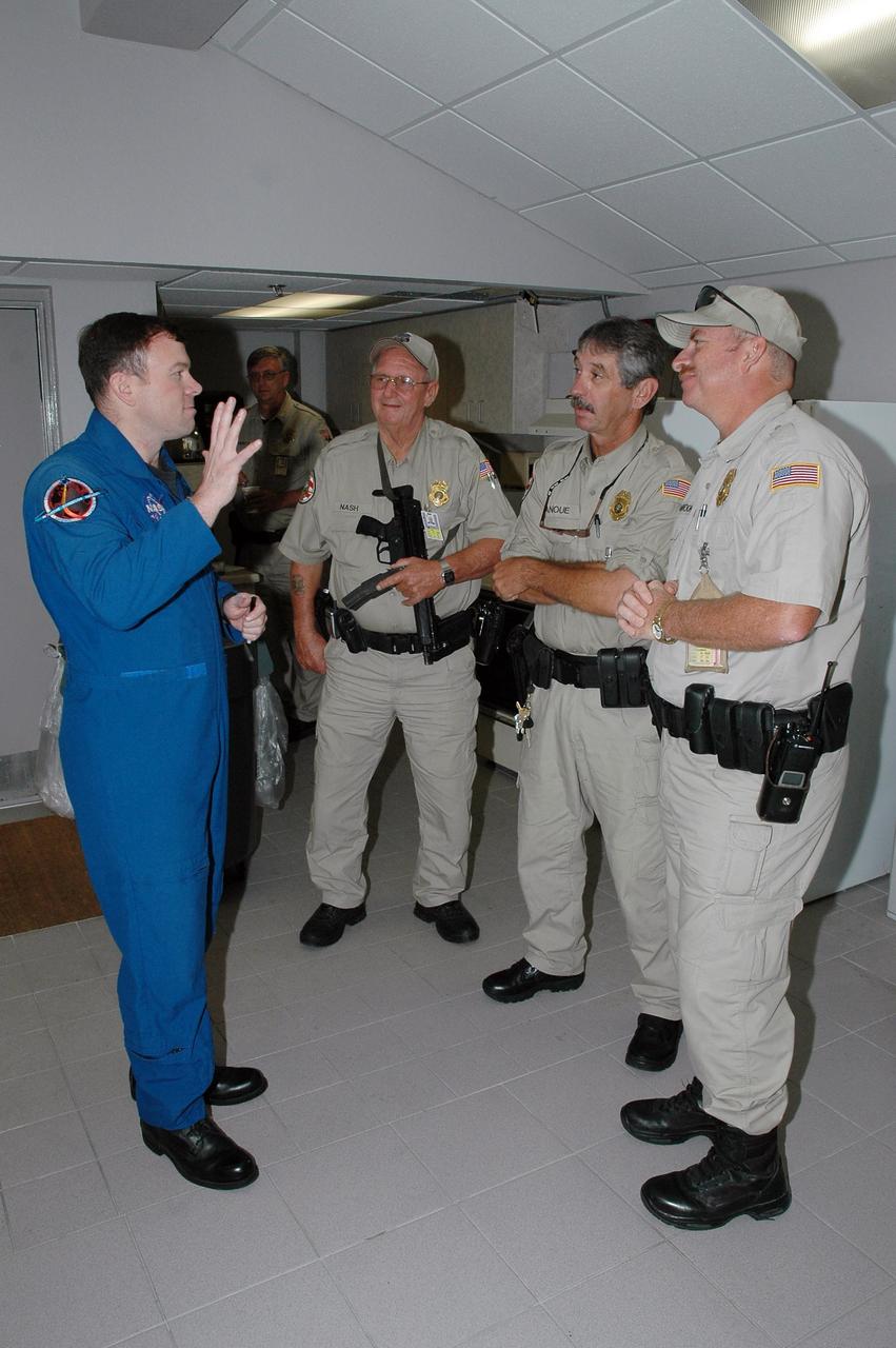 KENNEDY SPACE CENTER, FLA. -   STS-114 Pilot James Kelly (left) speaks to Kennedy Space Center and Cape Canaveral Air Force Station security personnel.  Kelly and the other crew members visited several sites during their return to the Center.  Their return is being celebrated at a gathering at the KSC Visitor Complex later this evening.