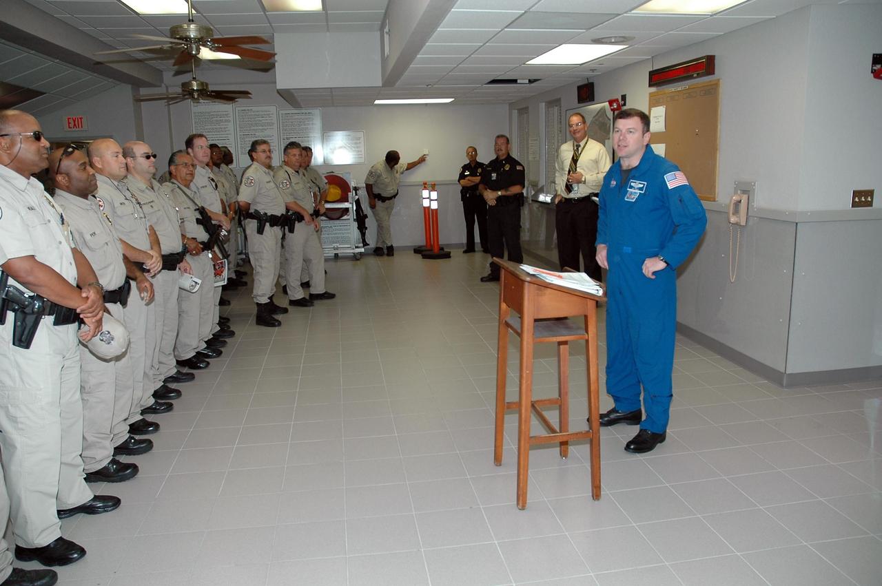 KENNEDY SPACE CENTER, FLA. -   STS-114 Pilot James Kelly (far right) speaks to Kennedy Space Center and Cape Canaveral Air Force Station security personnel.  Kelly and the other crew members visited several sites during their return to the Center.  Their return is being celebrated at a gathering at the KSC Visitor Complex later this evening.