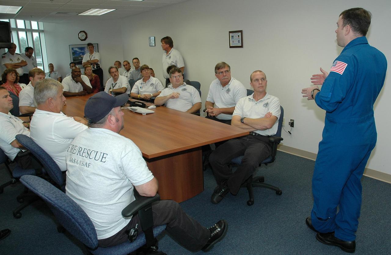 KENNEDY SPACE CENTER, FLA. -   STS-114 Pilot James Kelly (right) speaks to NASA and U. S. Air Force fire and rescue personnel. Kelly and the other crew members visited several sites during their return to the Center.  Their return is being celebrated at a gathering at the KSC Visitor Complex later this evening.