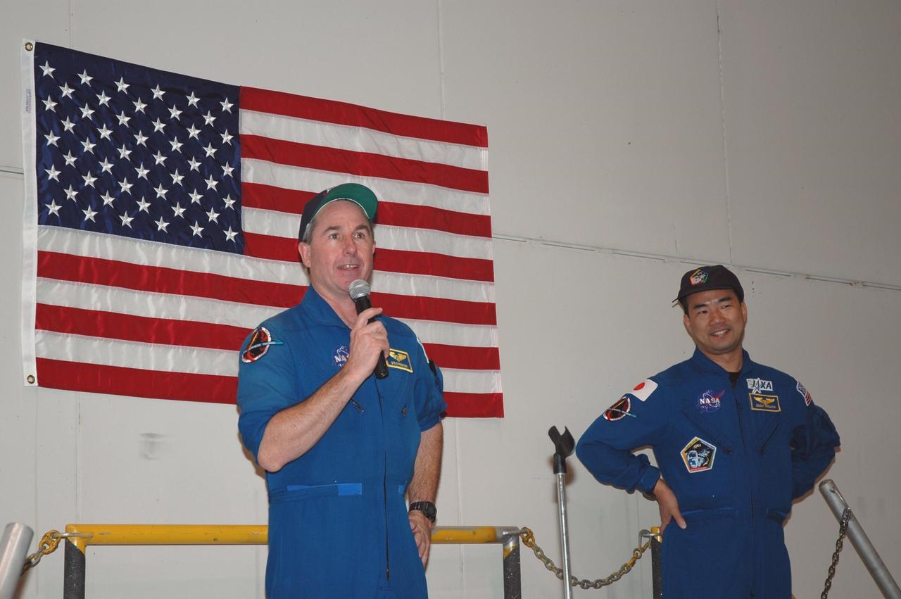 KENNEDY SPACE CENTER, FLA. -  In NASA Kennedy Space Center’s Assembly and  Refurbishment Facility, STS-114 Mission Specialist Stephen Robinson speaks to employees.  At right is Mission Specialist Soichi Noguchi.  They and other crew members are visiting several sites during their return to Kennedy Space Center. They have returned to Florida especially for a celebration in the KSC Visitor Complex of the successful return to flight mission that launched July 26 of this year.
