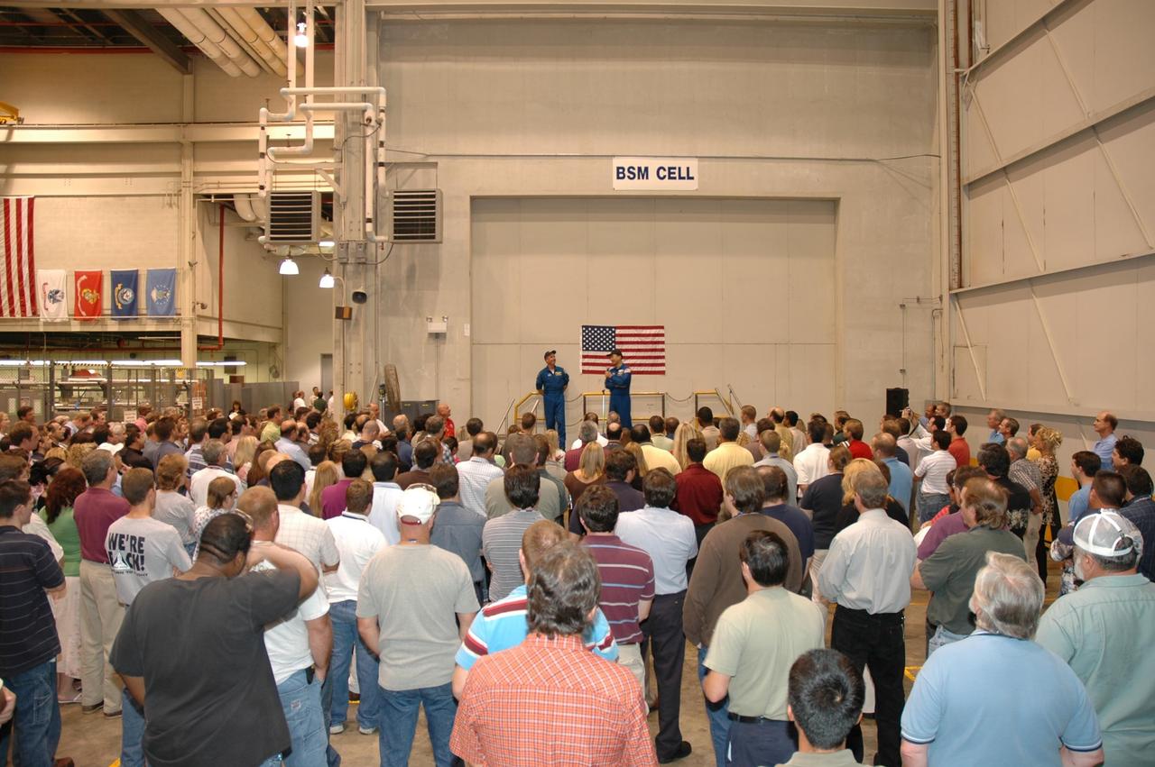 KENNEDY SPACE CENTER, FLA. -  In NASA Kennedy Space Center’s Assembly and  Refurbishment Facility, STS-114 Mission Specialists Soichi Noguchi and Stephen Robinson speak to a crowd of employees.  They and other crew members are visiting several sites during their return to Kennedy Space Center. They have returned to Florida especially for a celebration in the KSC Visitor Complex of the successful return to flight mission that launched July 26 of this year.