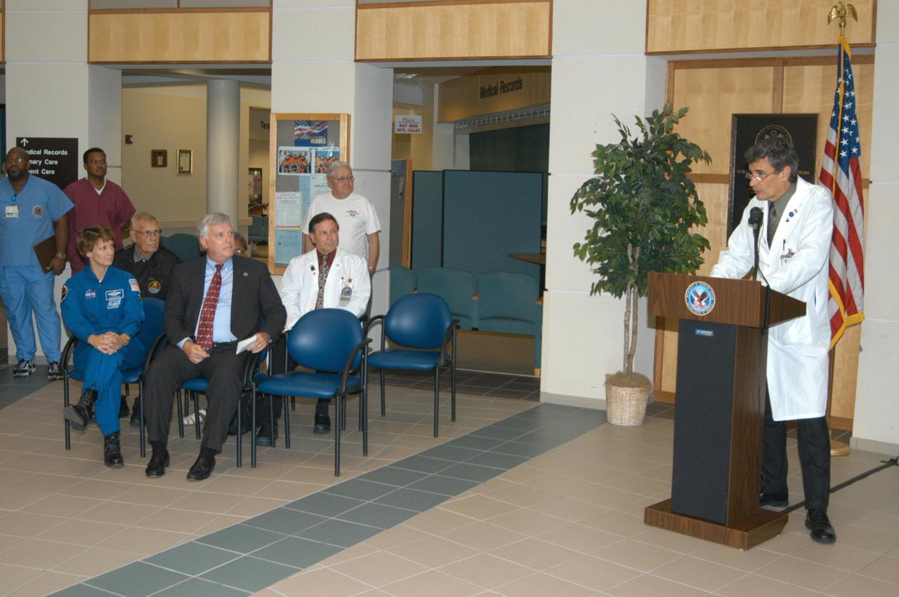 KENNEDY SPACE CENTER, FLA. -   Dr. Thomas Howard, chief medical officer at the V.A. Outpatient Clinic in Viera, Fla., speaks to guests during the dedication of a hospital wing in honor of space shuttle Discovery, to be known as the Discovery wing.  Joining in the dedication are, seated at left, STS-114 Mission Commander Eileen Collins, Norris Gray and Center Director  Jim Kennedy.  Gray was a long-time employee of Kennedy Space Center, in charge of fire safety from 1949 until his retirement in 1984.  Collins and her crew have returned to Florida especially for a celebration in the KSC Visitor Complex of the successful return to flight mission that launched July 26 of this year.