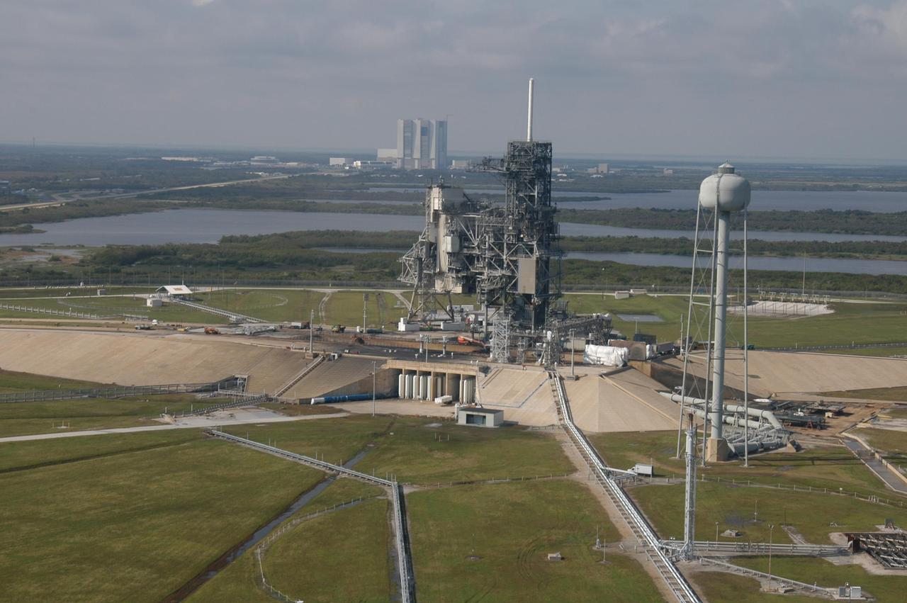 KENNEDY SPACE CENTER, FLA. - An aerial view of Launch Pad 39A at NASA Kennedy Space Center in Florida. In the background is the Vehicle Assembly Building. Atop the fixed service structure is the 80-foot-tall lightning mast. At right is the 290-foot-tall water tower that holds 300,000 gallons of water used at launch for sound suppression to protect the orbiter and its payloads from damage by acoustical energy and rocket exhaust reflected from the flame trench and Mobile Launcher Platform during launch.
