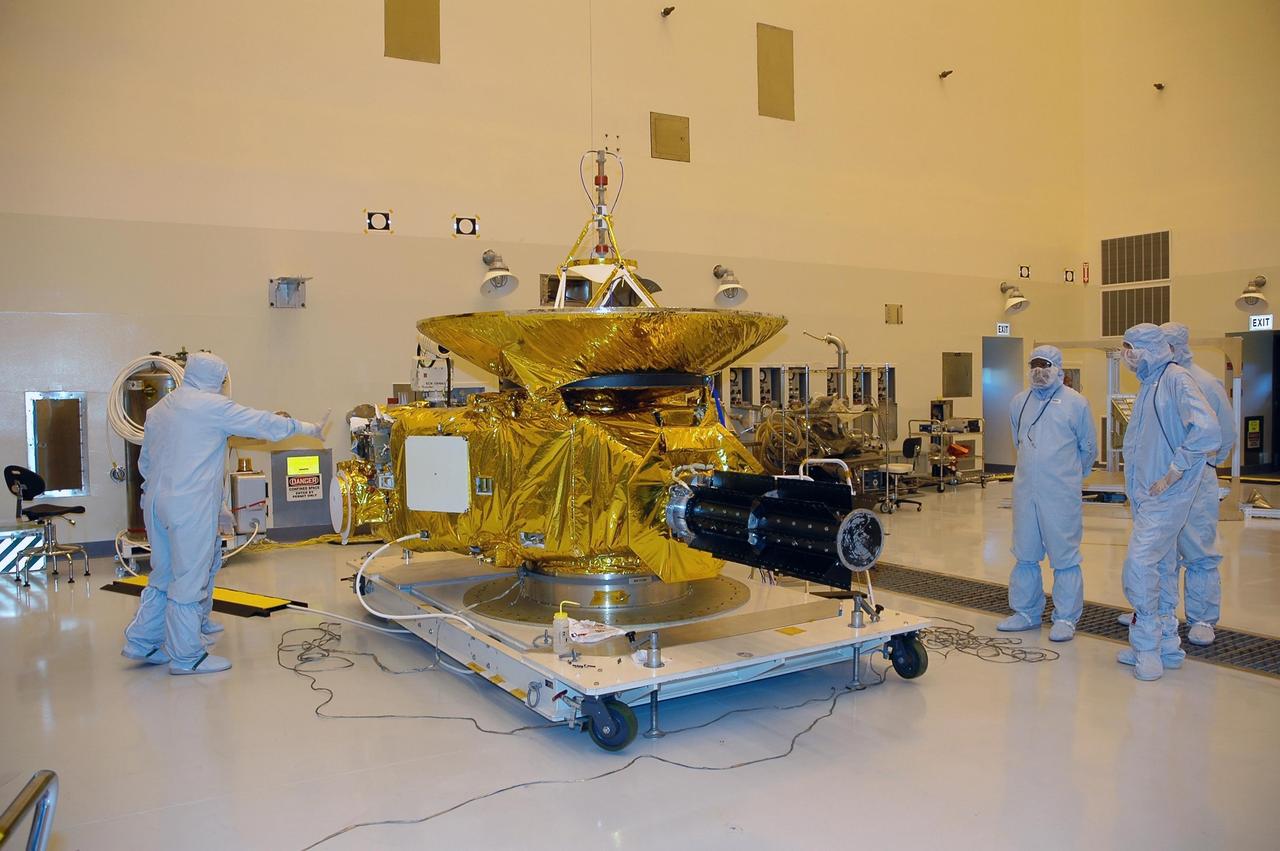 KENNEDY SPACE CENTER, FLA. - At NASA Kennedy Space Center’s Payload Hazardous Servicing Facility, technicians from the Applied Physics Laboratory are installing blankets that serve as heat shields around the New Horizons spacecraft. Carrying seven scientific instruments, the compact 1,060-pound New Horizons probe will characterize the global geology and geomorphology of Pluto and its moon Charon, map their surface compositions and temperatures, and examine Pluto's complex atmosphere. After that, flybys of Kuiper Belt objects from even farther in the solar system may be undertaken in an extended mission. New Horizons is the first mission in NASA's New Frontiers program of medium-class planetary missions. The spacecraft, designed for NASA by the Johns Hopkins University Applied Physics Laboratory in Laurel, Md., will fly by Pluto and Charon as early as summer 2015.
