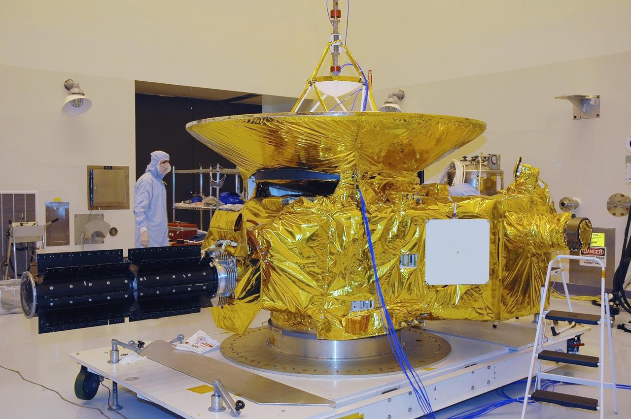 KENNEDY SPACE CENTER, FLA. - At NASA Kennedy Space Center’s Payload Hazardous Servicing Facility, the New Horizons spacecraft is shrouded in insulating blankets that were installed to serve as a heat shield. Carrying seven scientific instruments, the compact 1,060-pound New Horizons probe will characterize the global geology and geomorphology of Pluto and its moon Charon, map their surface compositions and temperatures, and examine Pluto's complex atmosphere. After that, flybys of Kuiper Belt objects from even farther in the solar system may be undertaken in an extended mission. New Horizons is the first mission in NASA's New Frontiers program of medium-class planetary missions. The spacecraft, designed for NASA by the Johns Hopkins University Applied Physics Laboratory in Laurel, Md., will fly by Pluto and Charon as early as summer 2015.