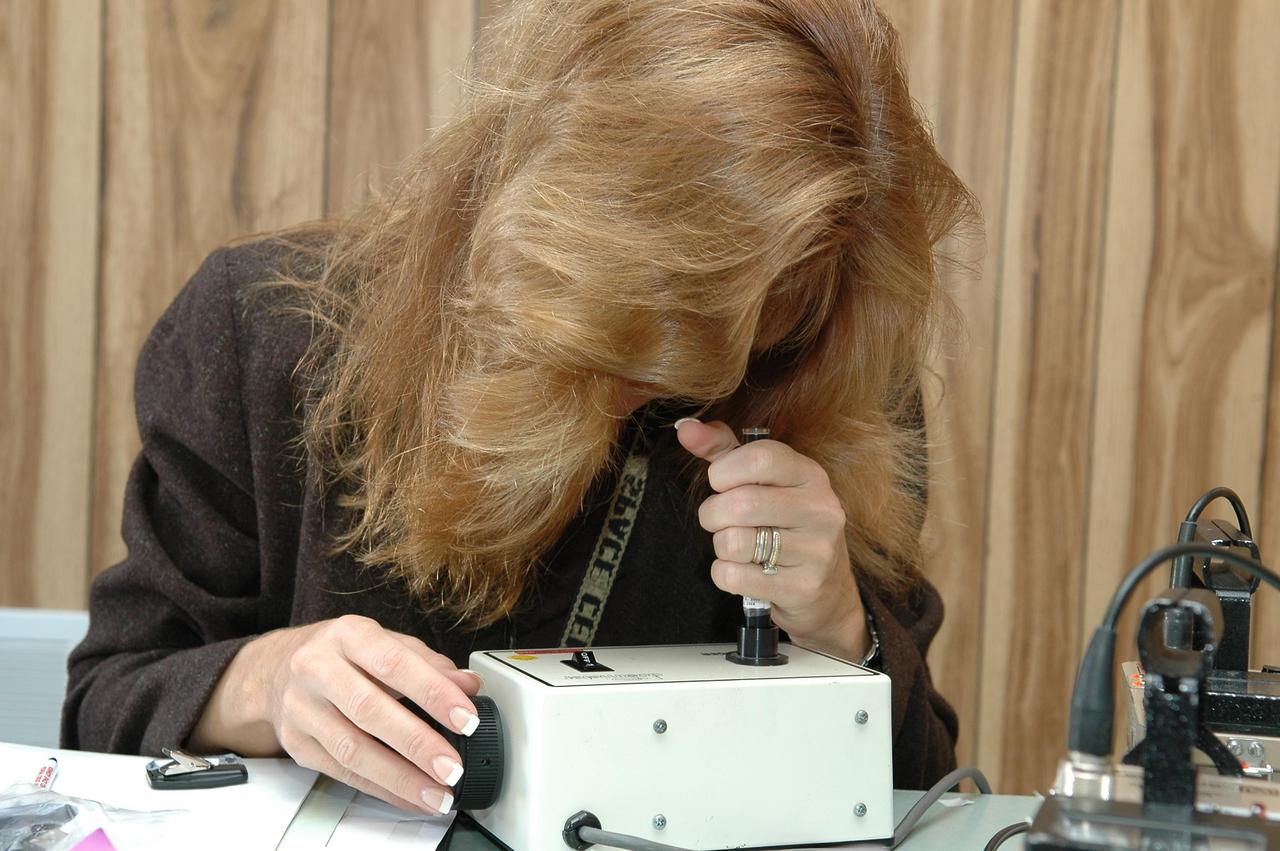 KENNEDY SPACE CENTER, FLA. - Jamie Gurney makes a zero adjustment of a personal dosimeter for officials handling the radioisotope thermoelectric generator (RTG) before its move to the RTG facility at Kennedy Space Center. The RTG is the baseline power supply for the NASA’s New Horizons spacecraft, scheduled to launch in January 2006 on a journey to Pluto and its moon, Charon. As it approaches Pluto, the spacecraft will look for ultraviolet emission from Pluto's atmosphere and make the best global maps of Pluto and Charon in green, blue, red and a special wavelength that is sensitive to methane frost on the surface. It will also take spectral maps in the near infrared, telling the science team about Pluto's and Charon's surface compositions and locations and temperatures of these materials. When the spacecraft is closest to Pluto or its moon, it will take close-up pictures in both visible and near-infrared wavelengths. It is expected to reach Pluto in July 2015.