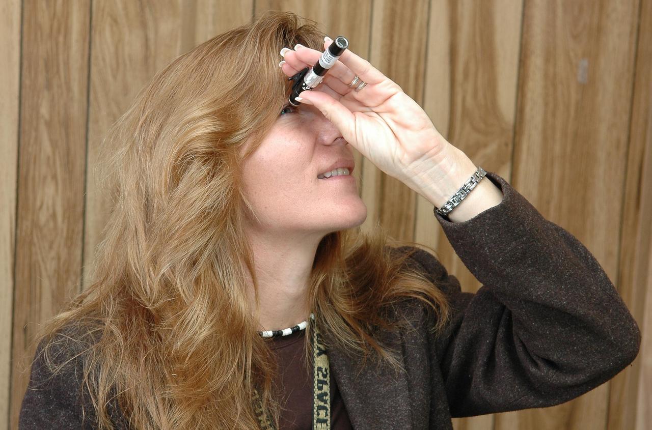 KENNEDY SPACE CENTER, FLA. - Jamie Gurney reads a personal dosimeter that will be used by officials handling the radioisotope thermoelectric generator (RTG) before its move to the RTG facility at Kennedy Space Center. The RTG is the baseline power supply for the NASA’s New Horizons spacecraft, scheduled to launch in January 2006 on a journey to Pluto and its moon, Charon. As it approaches Pluto, the spacecraft will look for ultraviolet emission from Pluto's atmosphere and make the best global maps of Pluto and Charon in green, blue, red and a special wavelength that is sensitive to methane frost on the surface. It will also take spectral maps in the near infrared, telling the science team about Pluto's and Charon's surface compositions and locations and temperatures of these materials. When the spacecraft is closest to Pluto or its moon, it will take close-up pictures in both visible and near-infrared wavelengths. It is expected to reach Pluto in July 2015.