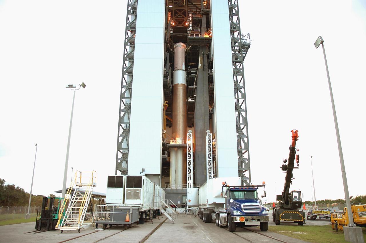 KENNEDY SPACE CENTER, FLA. - A transport trailer carrying a solid rocket booster arrives at the Vertical Integration Facility on Launch Complex 41 at Cape Canaveral Air Force Station in Florida. The booster rocket will be mated, along with others, to the Atlas V already in the VIF. The Atlas V is the launch vehicle for NASA’s New Horizons spacecraft, scheduled to launch in January 2006 on a journey to Pluto and its moon, Charon.