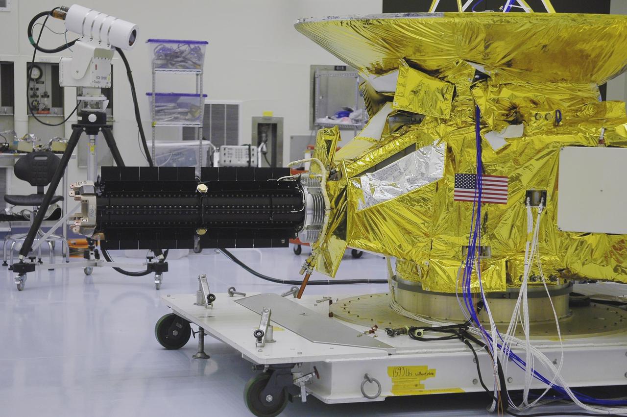 KENNEDY SPACE CENTER, FLA. - In NASA Kennedy Space Center’s Payload Hazardous Servicing Facility, In NASA Kennedy Space Center’s Payload Hazardous Servicing Facility, the radioisotope thermoelectric generator (RTG) has been installed onto the New Horizons spacecraft for a fit check. The RTG is the baseline power supply for New Horizons, scheduled to launch in January 2006 on a journey to Pluto and its moon, Charon. It is expected to reach Pluto in July 2015.