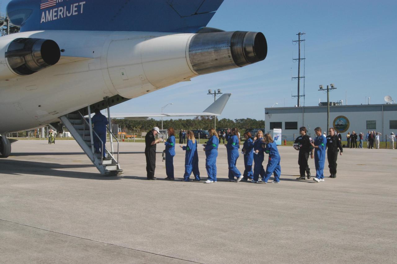 KENNEDY SPACE CENTER, FLA. -  The first group of passengers to fly on the ZERO-G aircraft line up.  The Boeing 727-200 aircraft is used for weightless flights by Zero Gravity Corporation, known as ZERO-G, of Fort Lauderdale, Fla.  NASA and ZERO-G demonstrated Nov. 5 the expanded access to and use of the space shuttle's runway and landing facility at Kennedy Space Center for non-NASA activities.  The passengers, called "Flyers," were predominantly teachers who performed simple microgravity experiments they can share with their students back in the classroom.
