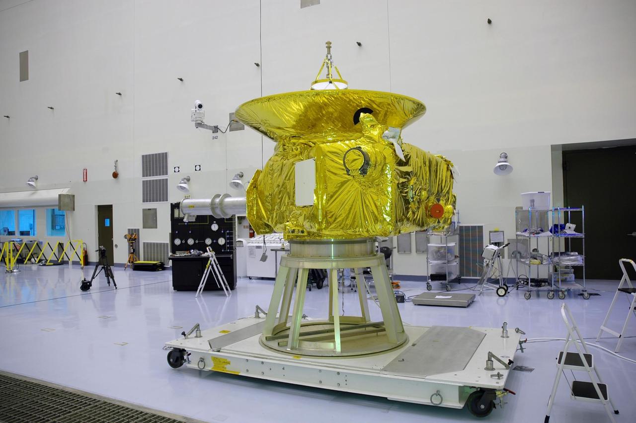 KENNEDY SPACE CENTER, FLA. - In NASA Kennedy Space Center’s Payload Hazardous Servicing Facility, the New Horizons spacecraft sits on a work stand prior to being moved to a spin table.  The spacecraft will undergo a spin test as part of prelaunch processing.  New Horizons is expected to be launched in January 2006 on a journey to Pluto and its moon, Charon.  It is expected to reach Pluto in July 2015.