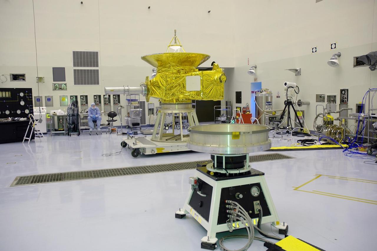 KENNEDY SPACE CENTER, FLA. - In NASA Kennedy Space Center’s Payload Hazardous Servicing Facility, the New Horizons spacecraft, in the background, sits on a work stand prior to being moved to a spin table, seen in the foreground.  The spacecraft will undergo a spin test as part of prelaunch processing.  New Horizons is expected to be launched in January 2006 on a journey to Pluto and its moon, Charon.  It is expected to reach Pluto in July 2015.