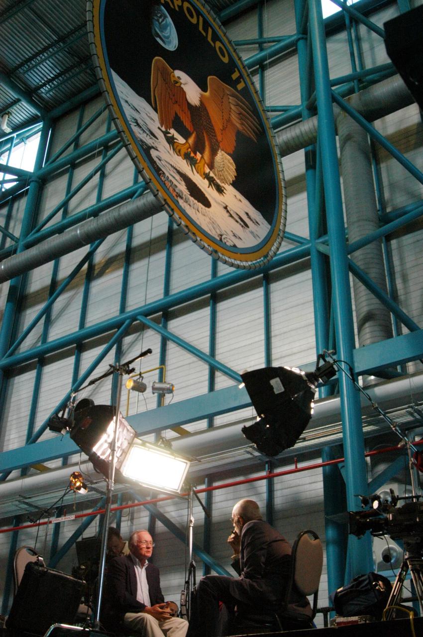 KENNEDY SPACE CENTER, FLA. -  The CBS news program “60 Minutes” is taping a segment inside NASA Kennedy Space Center’s Apollo/Saturn V Center.  Correspondent Ed Bradley (right) is seen here interviewing former astronaut Neil Armstrong, the subject of the interview.  They talked about Armstrong’s historic milestone - walking on the moon - and the public’s response and affect on his career afterward. The show aired Nov. 6.