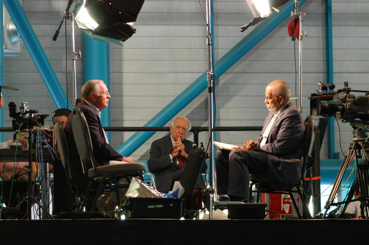 KENNEDY SPACE CENTER, FLA. -   The CBS news program “60 Minutes” is taping a segment inside NASA Kennedy Space Center’s Apollo/Saturn V Center.  Correspondent Ed Bradley (right) is seen here interviewing former astronaut Neil Armstrong, the subject of the interview.  They talked about Armstrong’s historic milestone - walking on the moon - and the public’s response and affect on his career afterward.  In the background is CBS broadcaster Walter Cronkite, who reunited with Armstrong for the 60 Minutes show. The show aired Nov. 6.